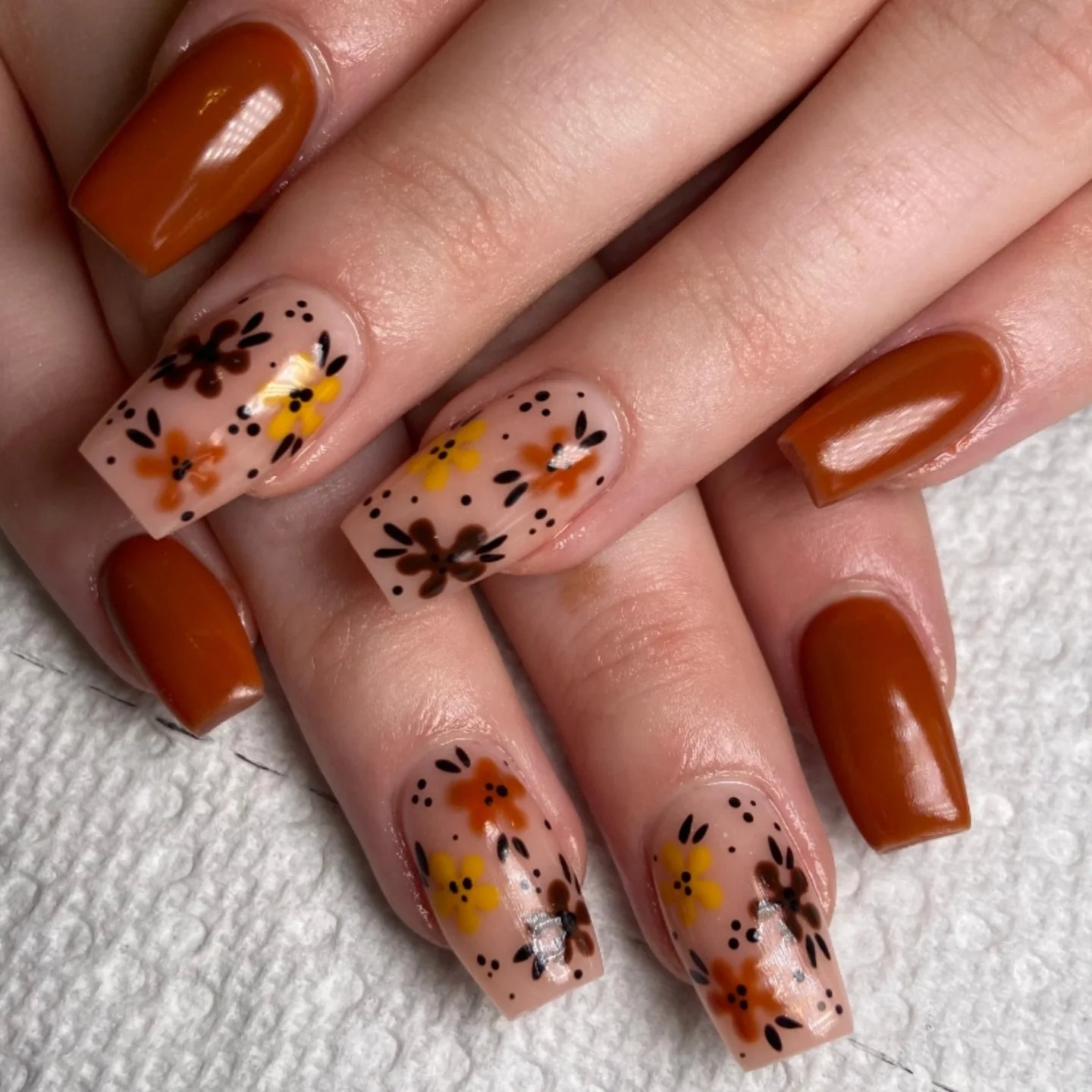 25 Fall Nail Ideas You Need to Try in 2026 8 Autumn Floral Accents With Glossy Brown Nails