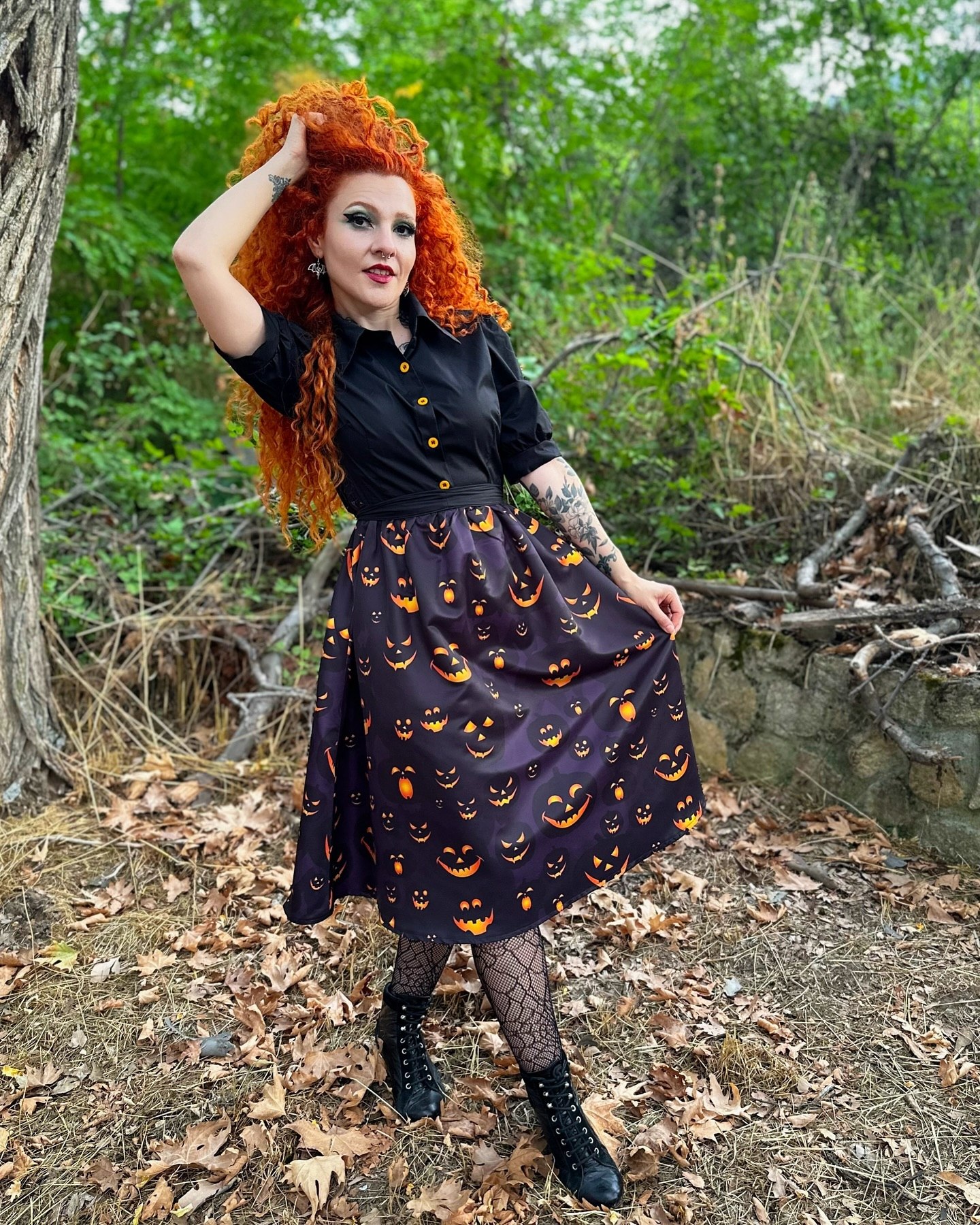 25 Witchy Outfit Ideas for 2026 4 Bewitching Black Shirt With Jack-o'-lantern Midi Skirt