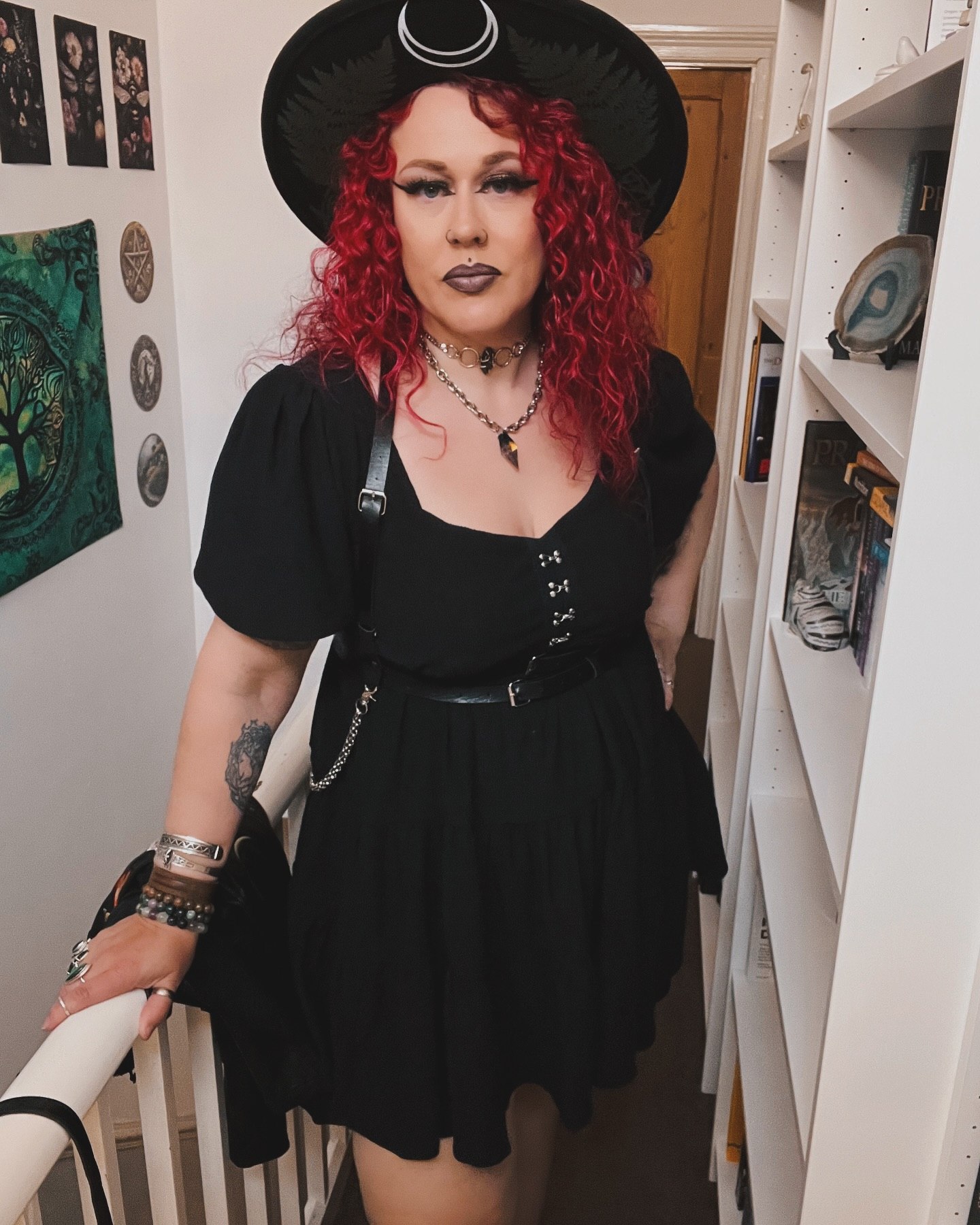 25 Witchy Outfit Ideas for 2026 7 Black Puff Sleeve Dress With Harness and Witch Hat
