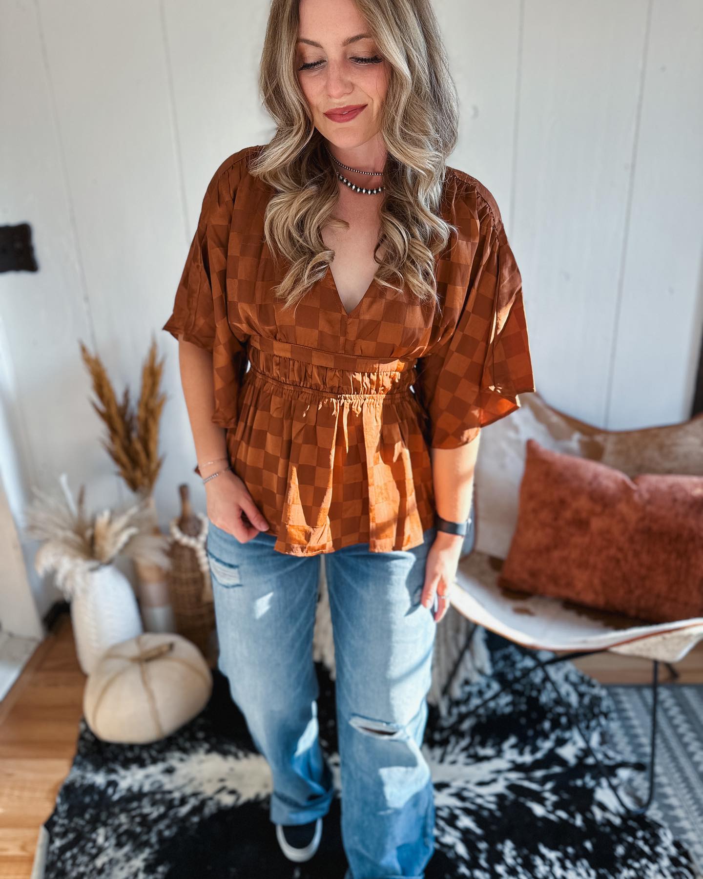 25 Fall Festival Outfits You Need for 2026 22 Bohemian Checkered Top With Distressed Denim