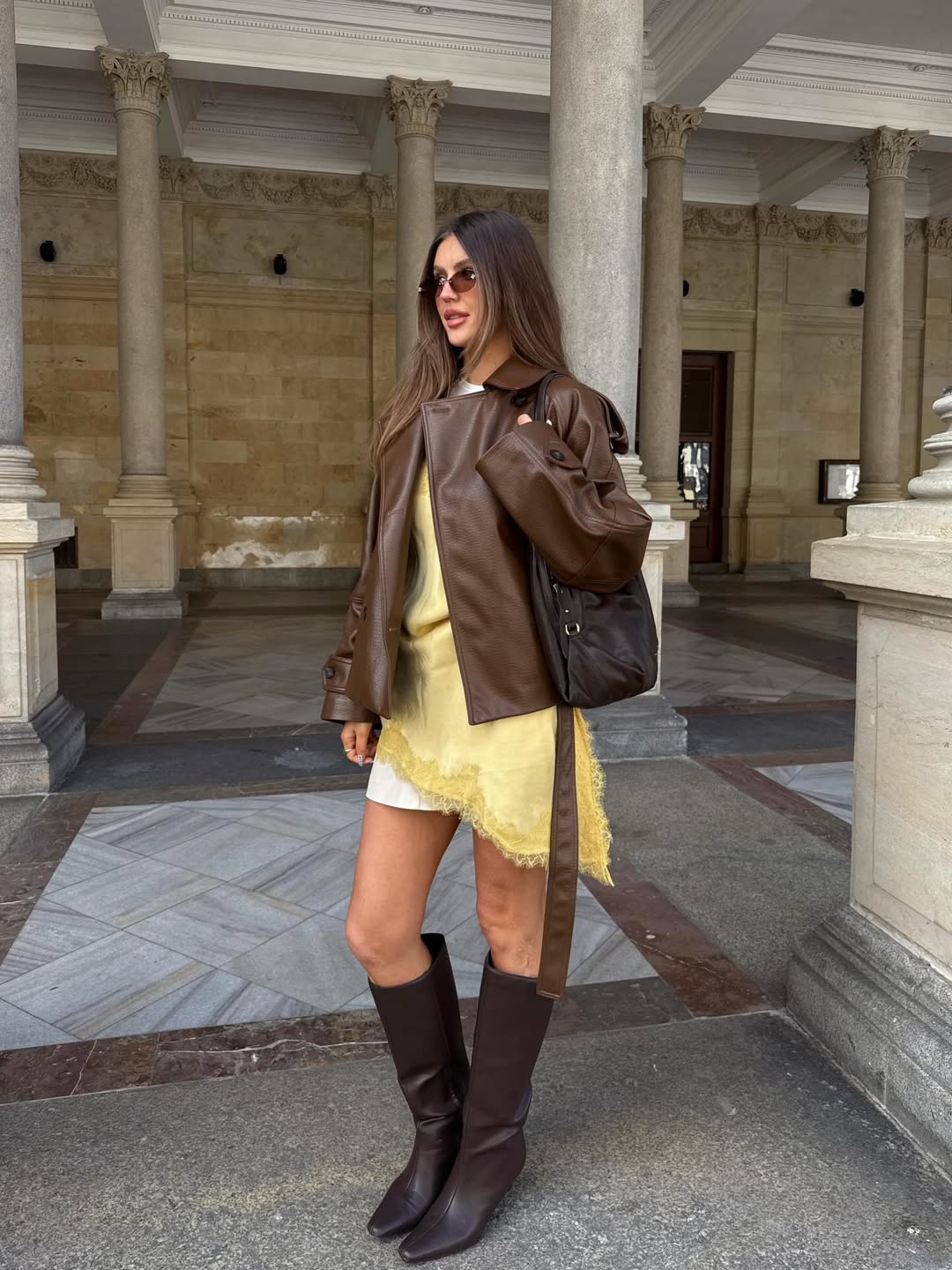 25 Fall Party Outfit Ideas You Need for 2026 11 Brown Leather Jacket Over Yellow Slip Dress