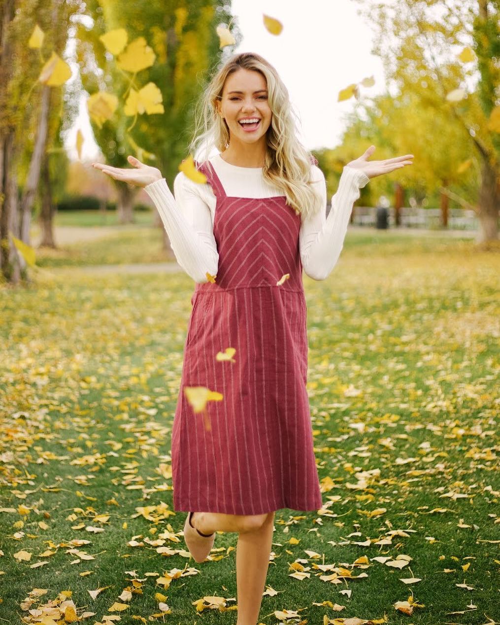 25 Fall Party Outfit Ideas You Need for 2026 16 Cozy Burgundy Pinafore Dress With Cream Knit