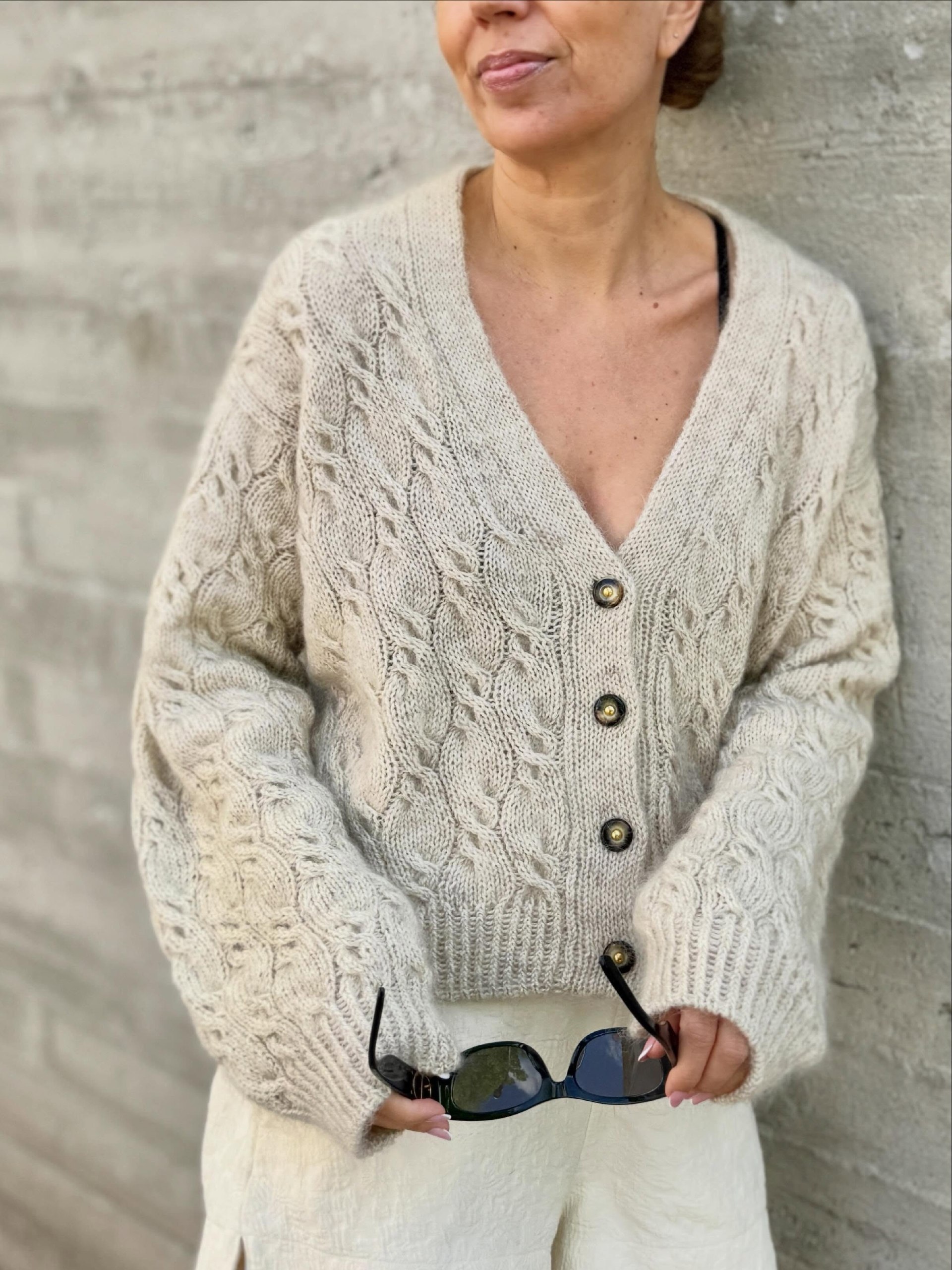 27 Cardigan Outfit Ideas You Need for 2026 13 Cream Cable Knit Cardigan With Textured White Trousers