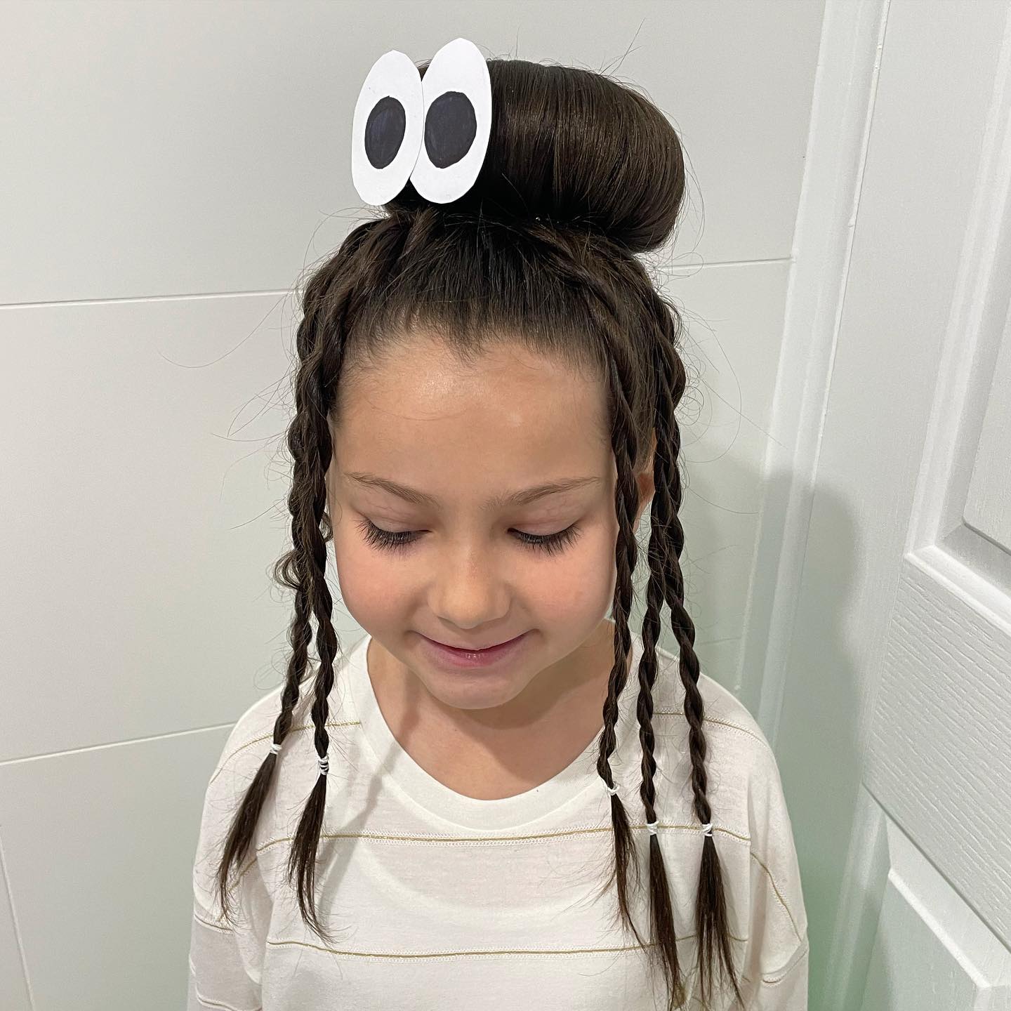 27 Spooktacular Halloween Hairstyles for Kids 2026 25 Cute Monster Eye Braids With Top Knot