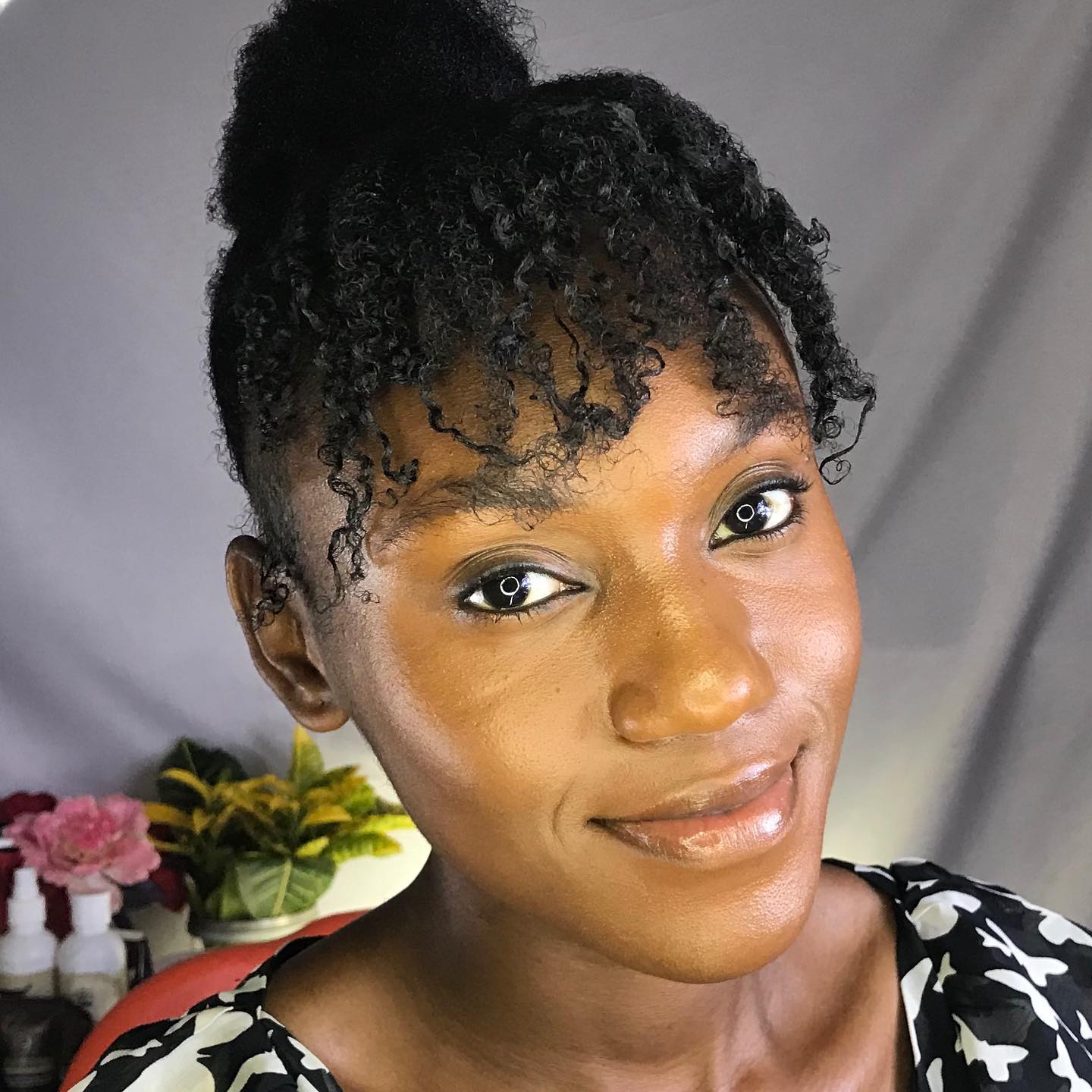 25 Stunning Type 4c Hairstyles You’ll See Everywhere in 2026 12 Elevated High Bun With Curly Face-Framing Tendrils