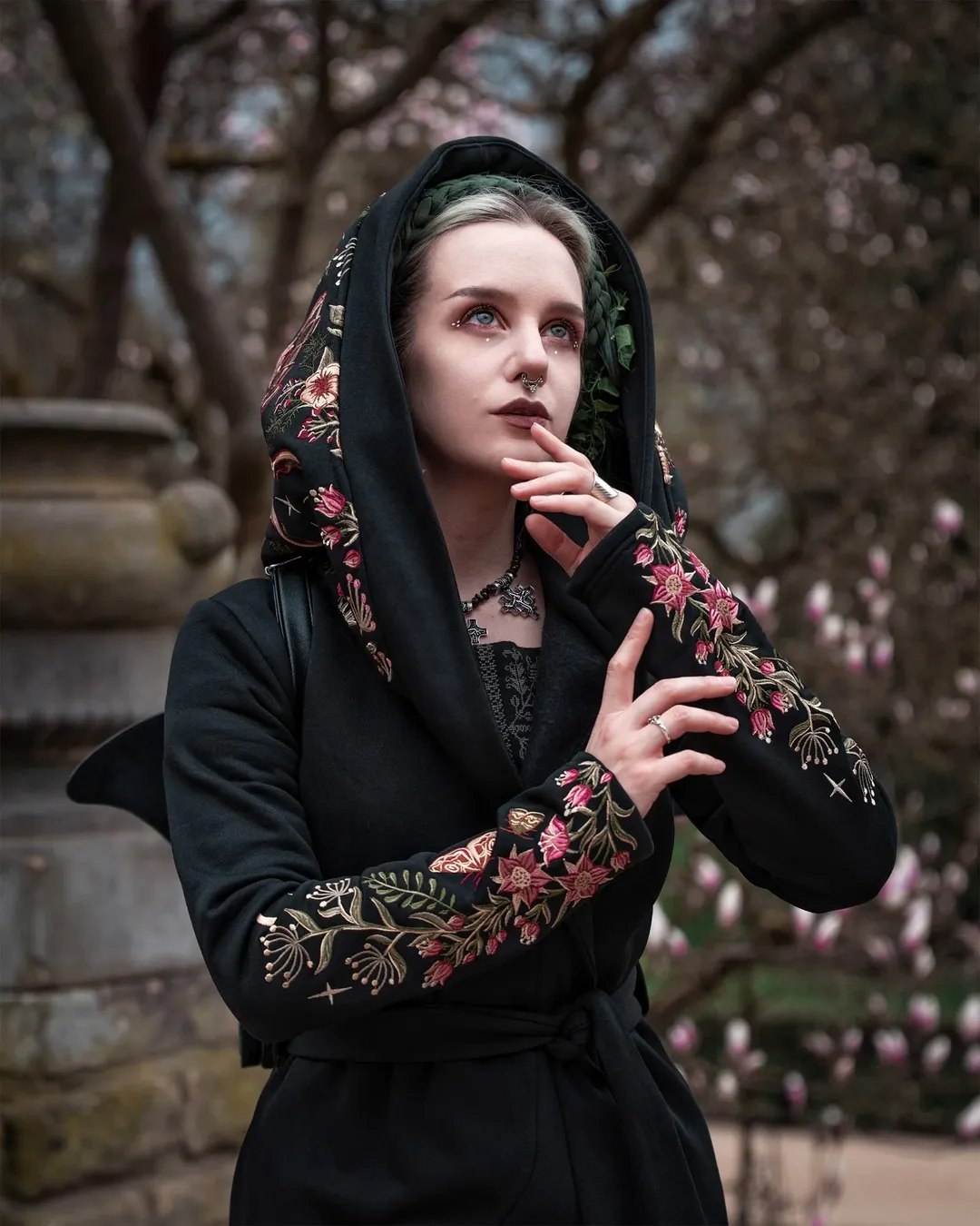 25 Witchy Outfit Ideas for 2026 19 Embroidered Black Hooded Coat With Gothic Dress
