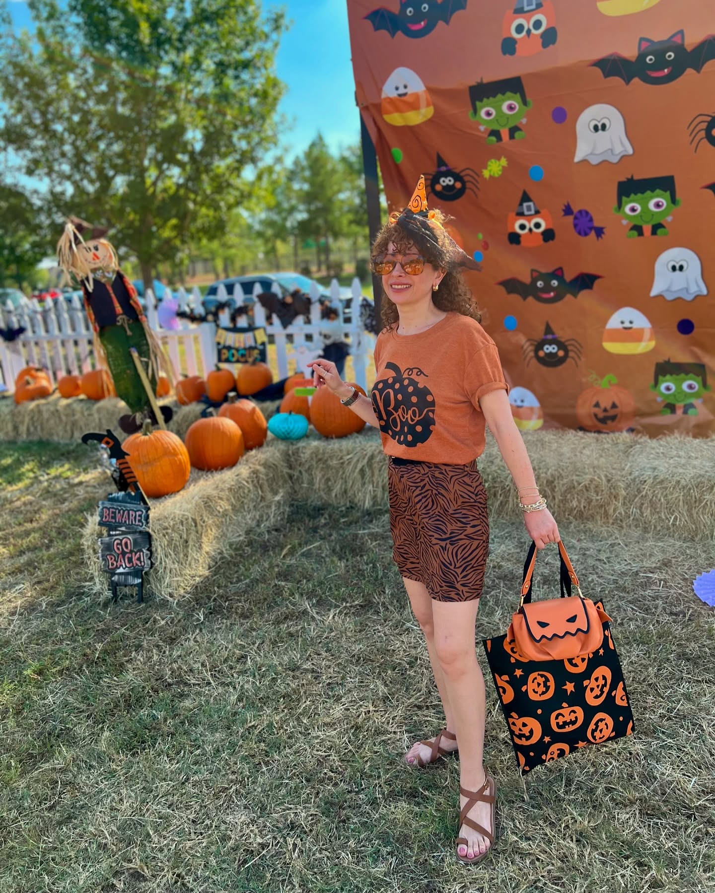 27 Spooktacular Halloween Outfits You Need for 2026 11 Fun Pumpkin Graphic Tee And Tiger Print Skirt
