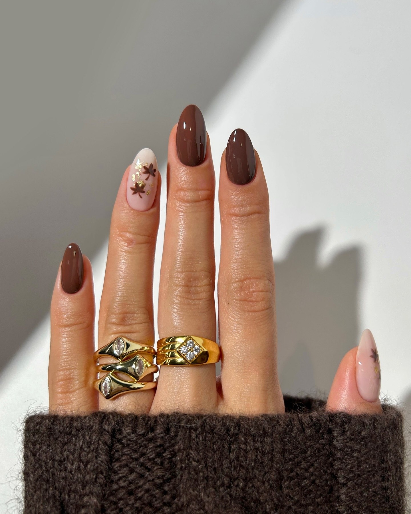 Glossy Chocolate Ombre Almond Nails with Gold Leaf Accents