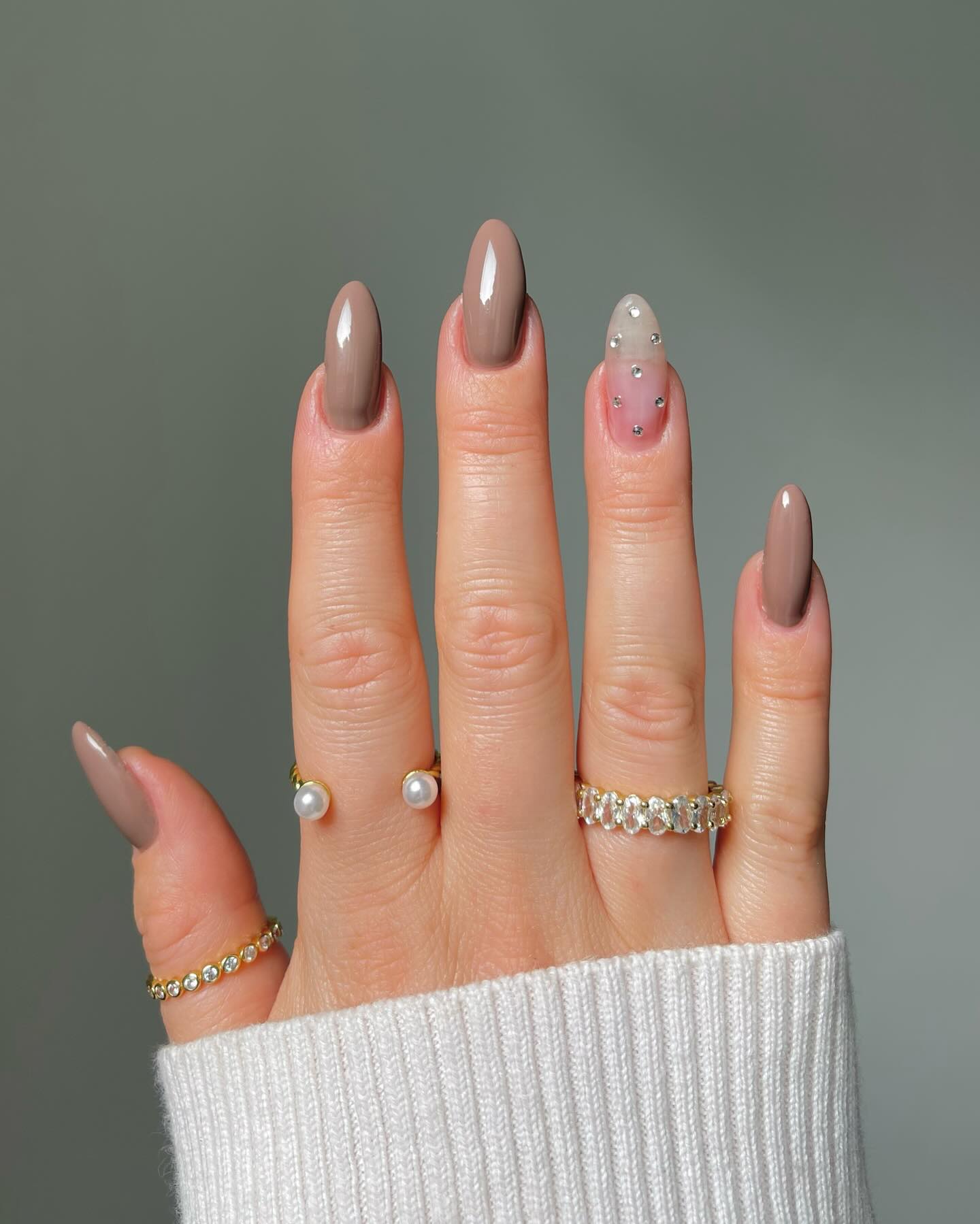 27 Chic Neutral Fall Nail Ideas You Need for 2026 26 Neutral Taupe Almond Nails with Rhinestone Accent