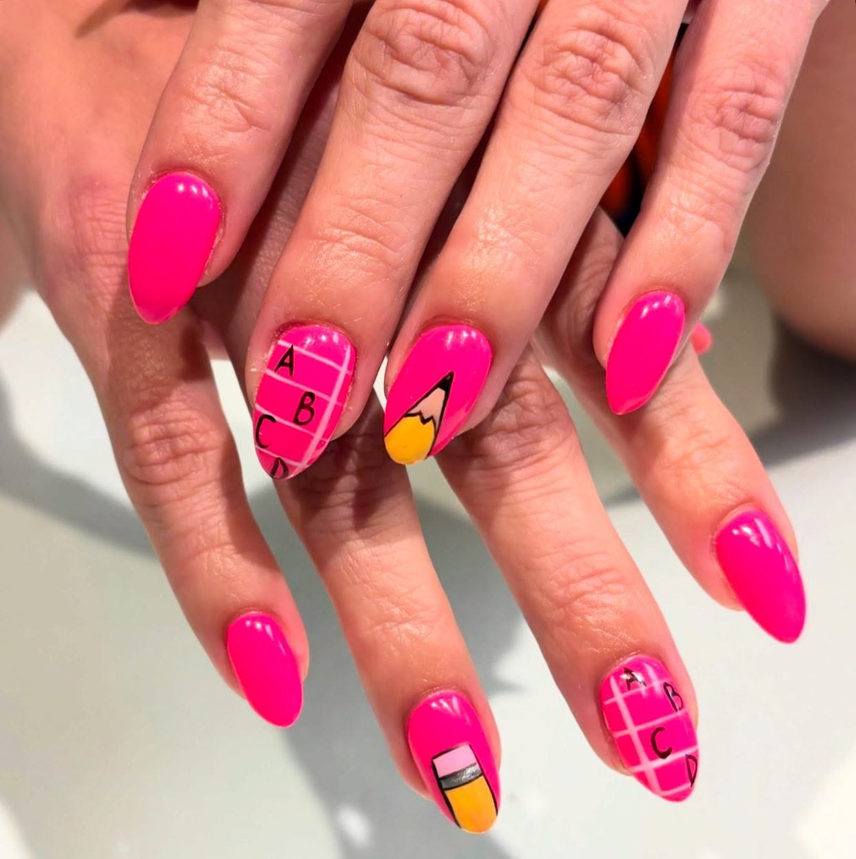 27 Back to School Nail Ideas for Teens 2026 21 Pink Neon Pencil & ABC Grid Almond Nails