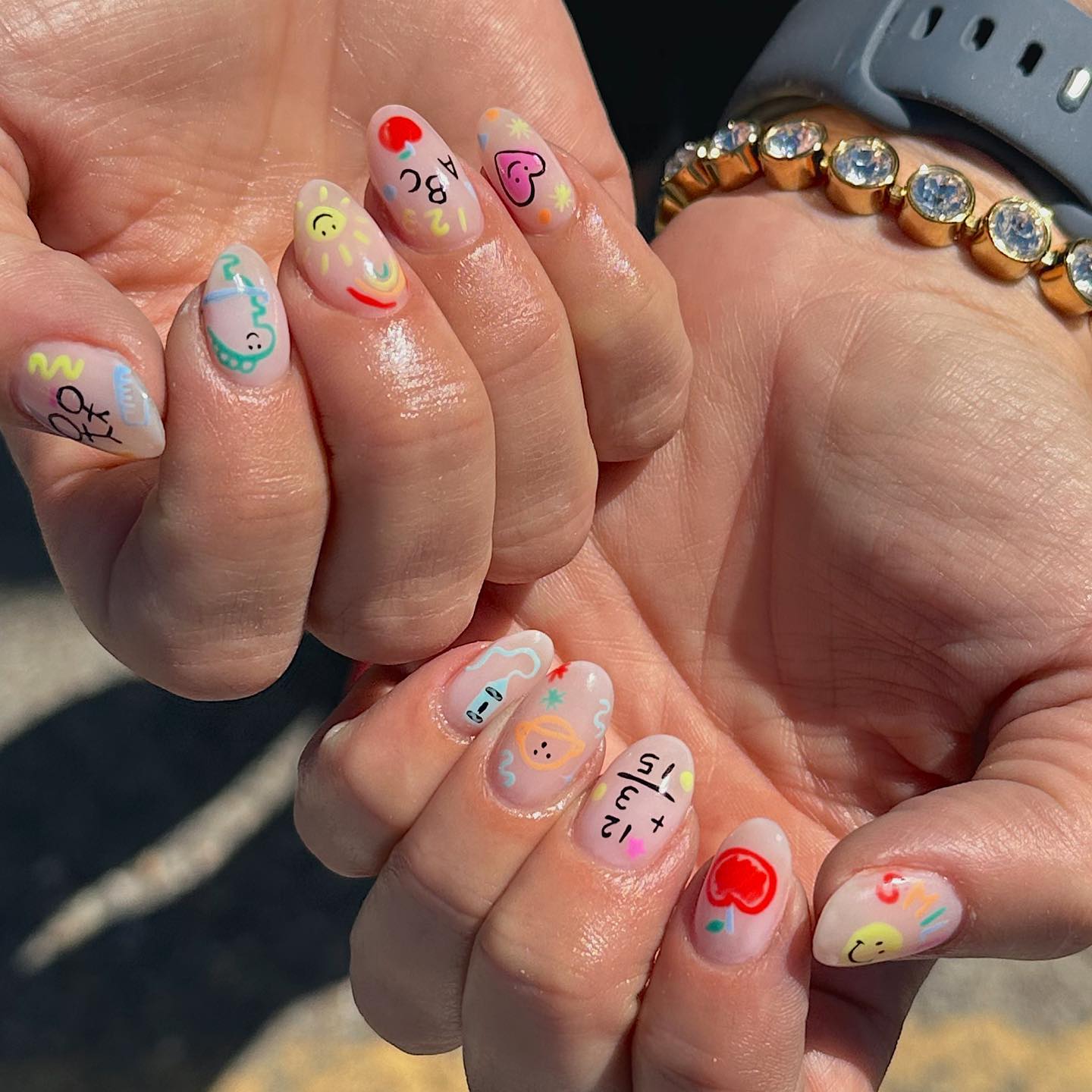 27 Back to School Nail Ideas for Teens 2026 7 Playful ABCs and Smiling Sun Back-to-School Almond Nails