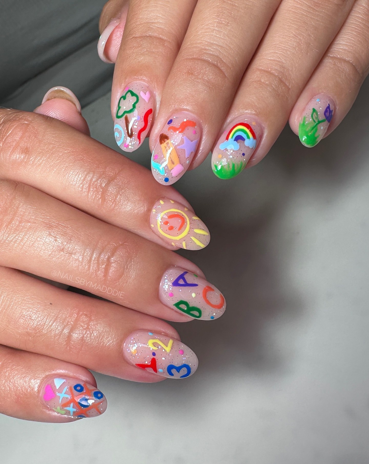 27 Back to School Nail Ideas for Teens 2026 4 Playful Cartoon School Day Themed Oval Nails