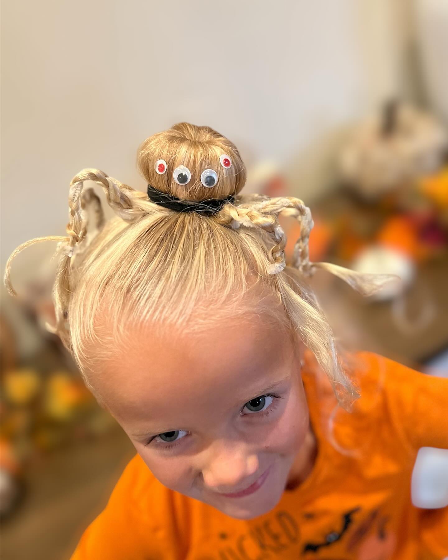 27 Spooktacular Halloween Hairstyles for Kids 2026 5 Spider Bun With Googly Eyes Halloween Hairstyle