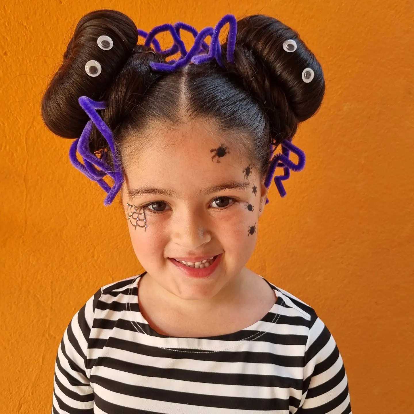27 Spooktacular Halloween Hairstyles for Kids 2026 8 Spider Web Buns With Googly Eye Accent