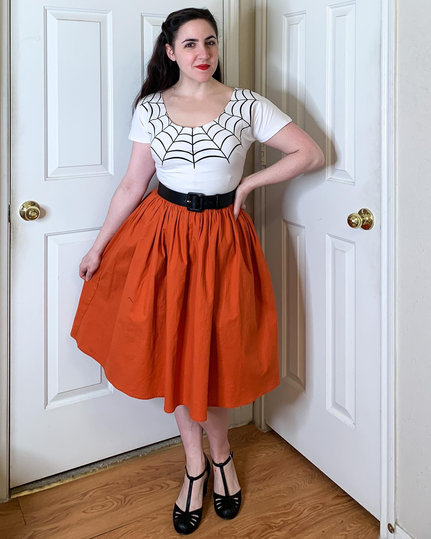27 Spooktacular Halloween Outfits You Need for 2026 10 Spiderweb Top With Voluminous Orange Skirt