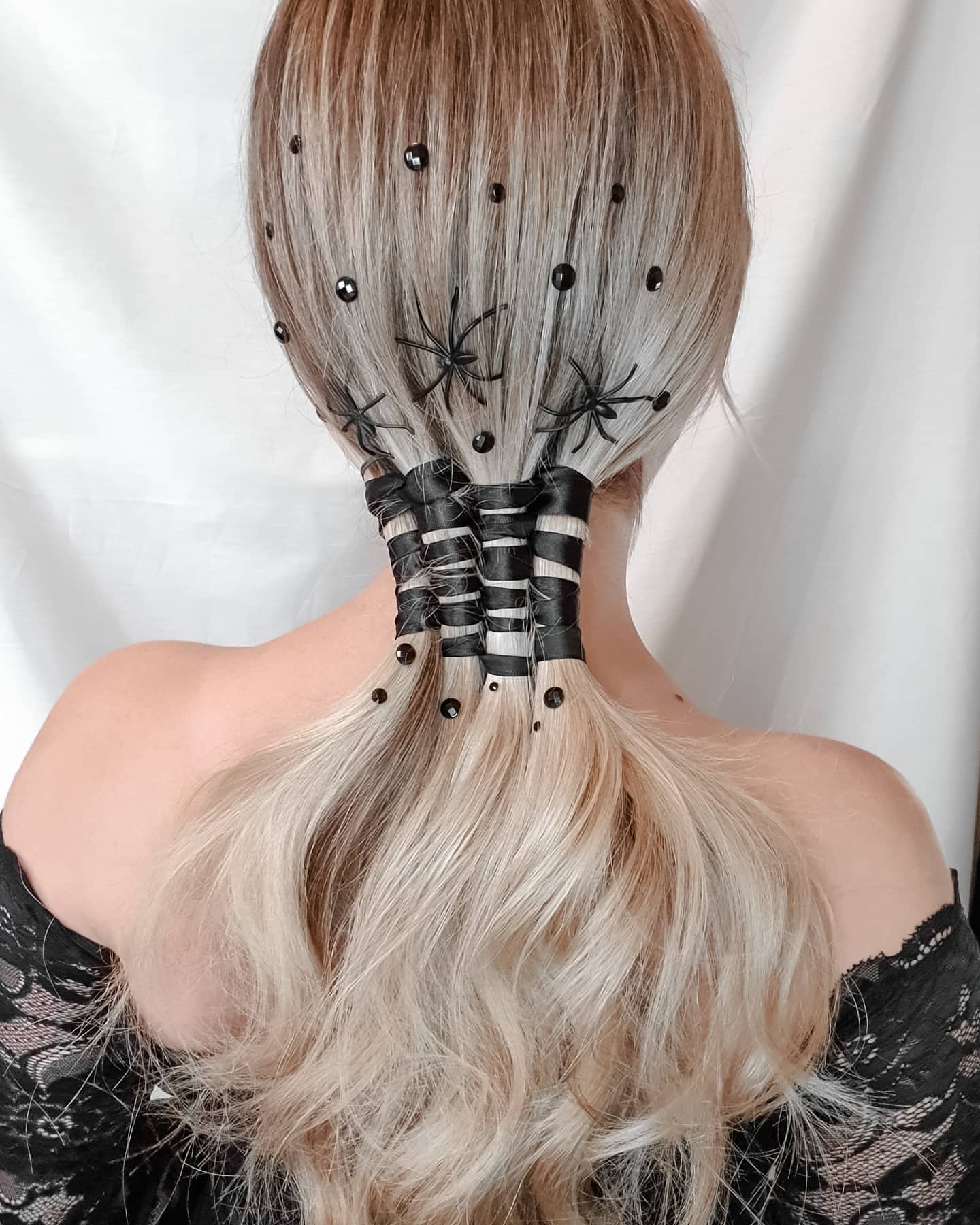 25 Spooktacular Halloween Hairstyles You Need to Try in 2026 4 Spooky Spider Web Low Ponytail for Halloween
