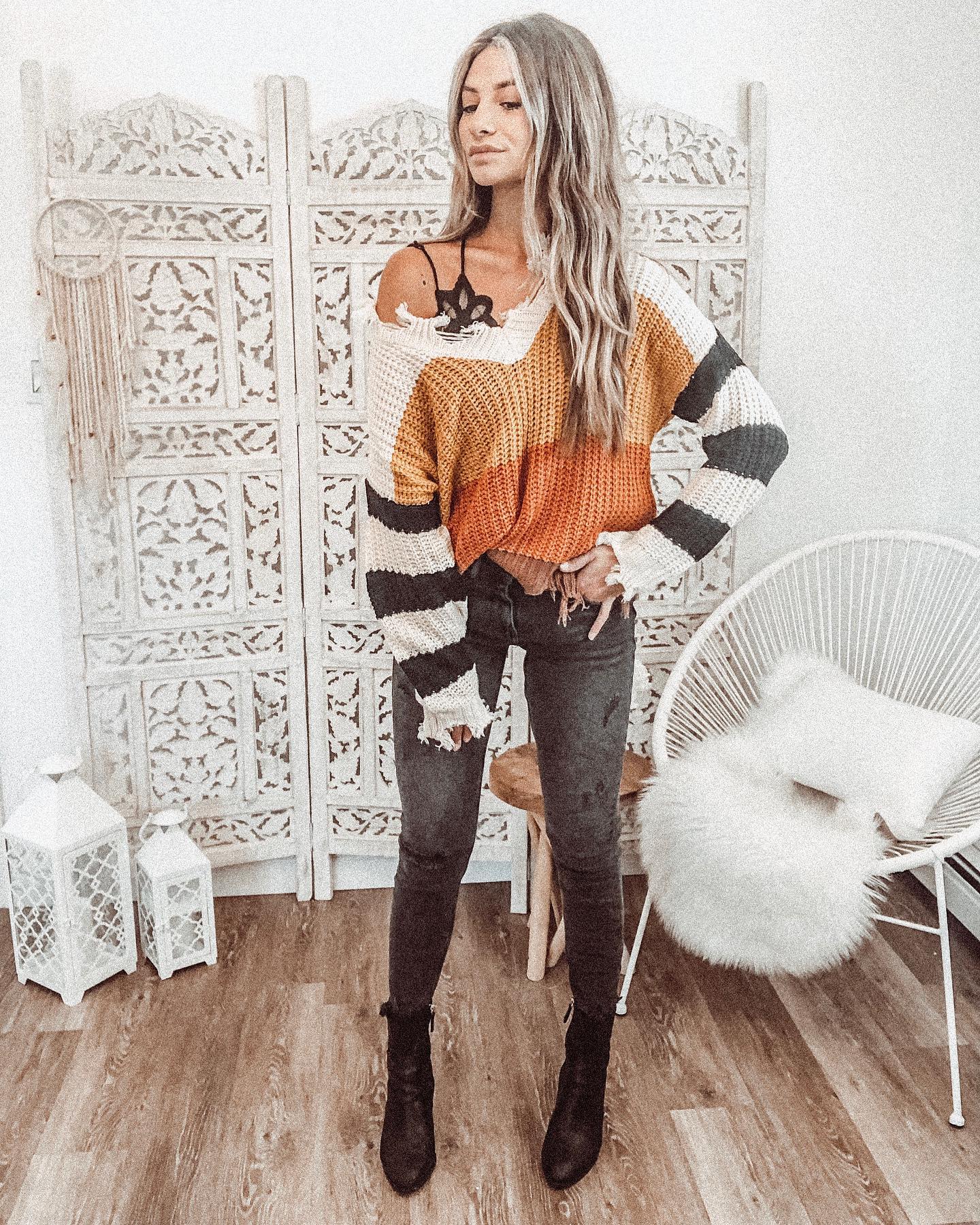 25 Fall Festival Outfits You Need for 2026 27 Striped Knit Sweater With Distressed Denim And Ankle Boots