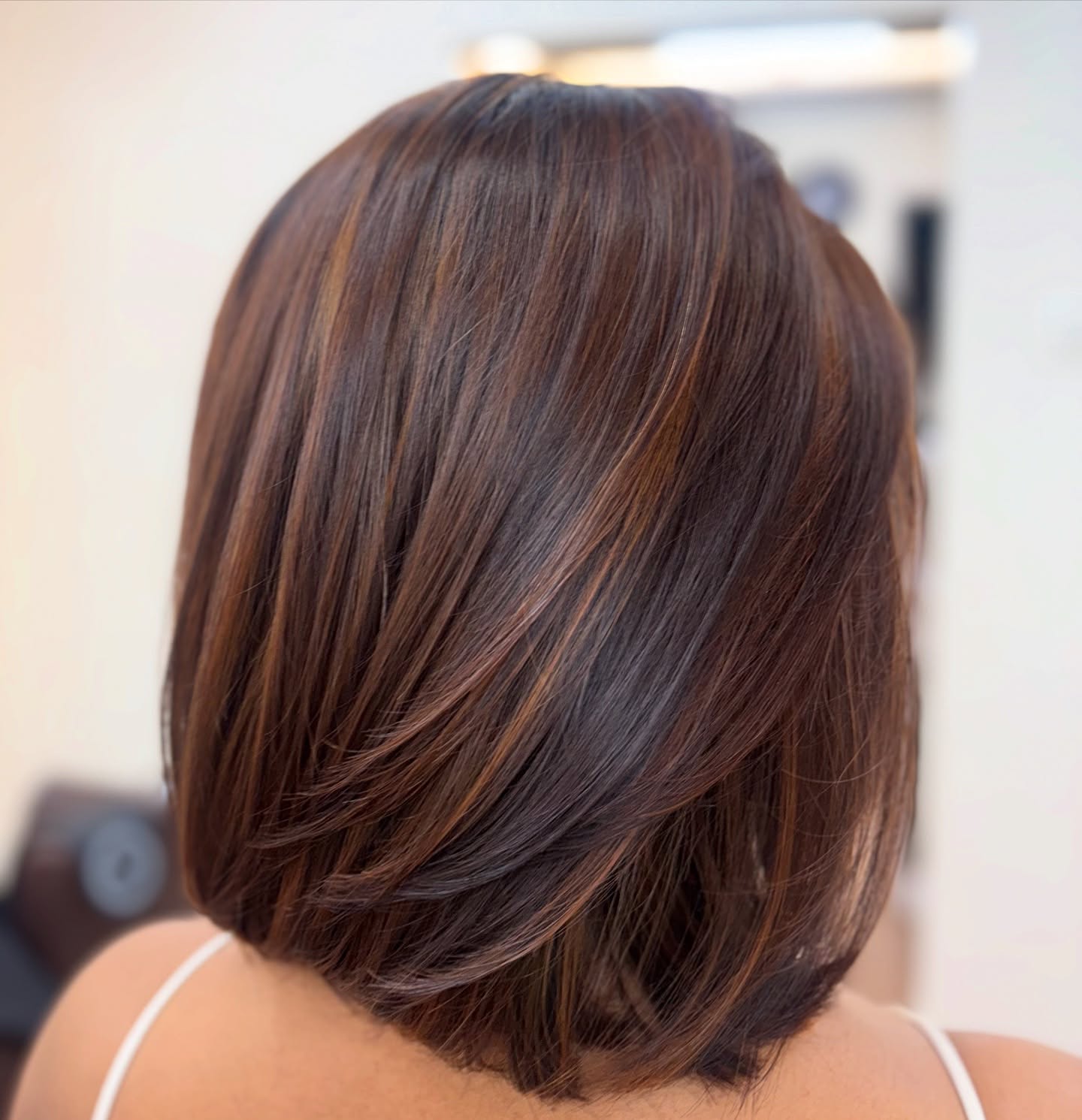 25 Stunning Brown Cinnamon Hair Color Ideas for 2026 21 Subtle Cinnamon Highlights On A Layered Bob