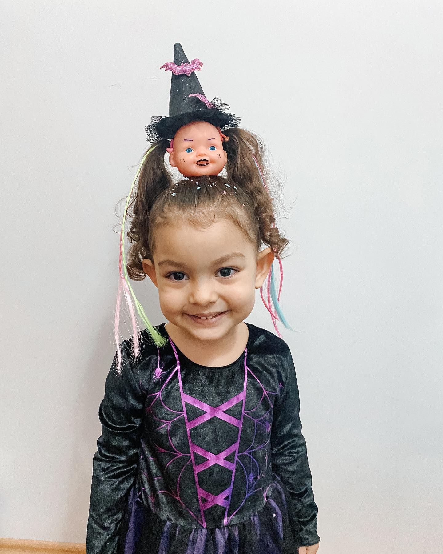 27 Spooktacular Halloween Hairstyles for Kids 2026 23 Wicked Doll Head Twin Pigtails With Color Streaks
