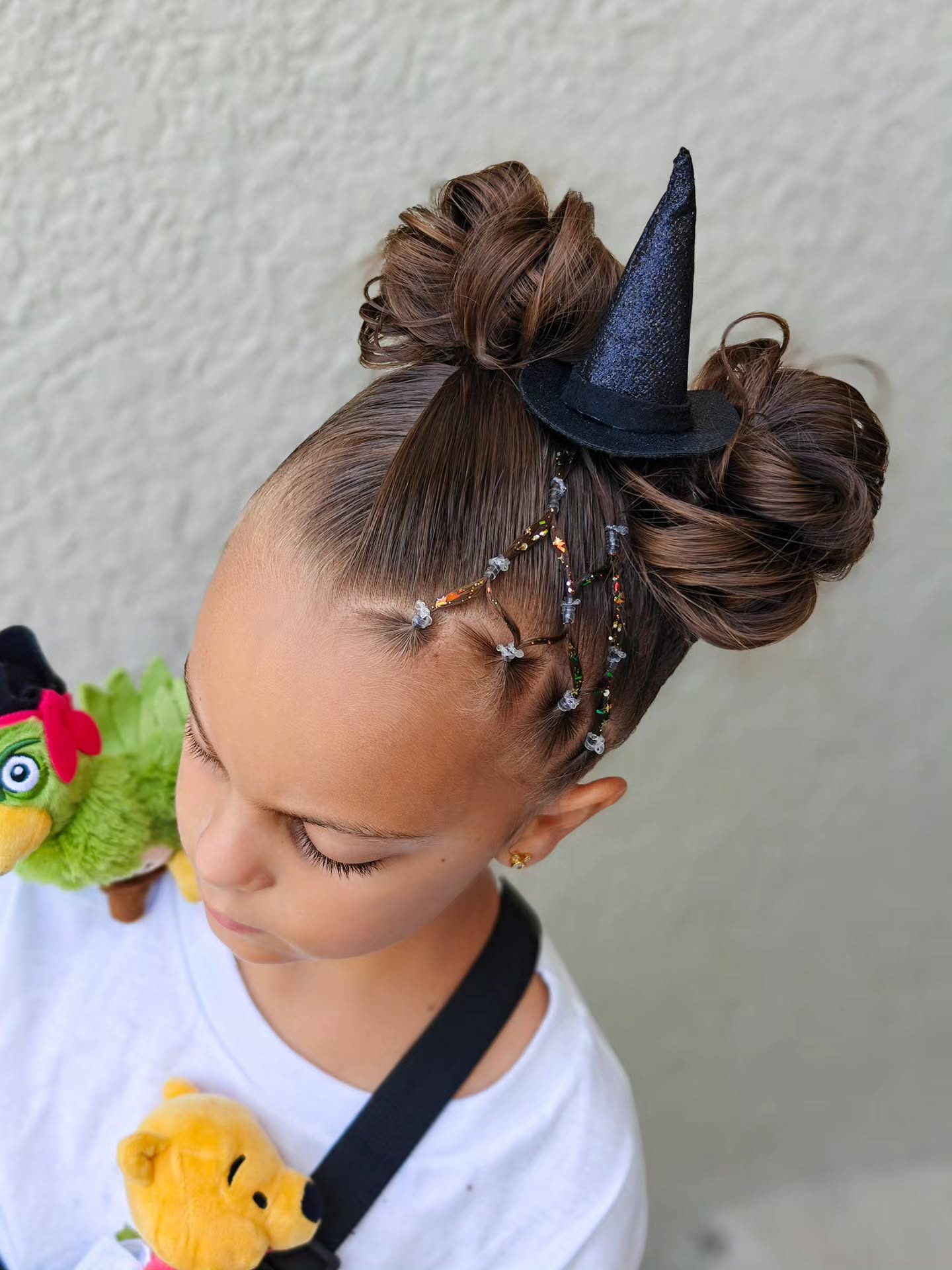 27 Spooktacular Halloween Hairstyles for Kids 2026 26 Witchy Double Buns With Beaded Strands