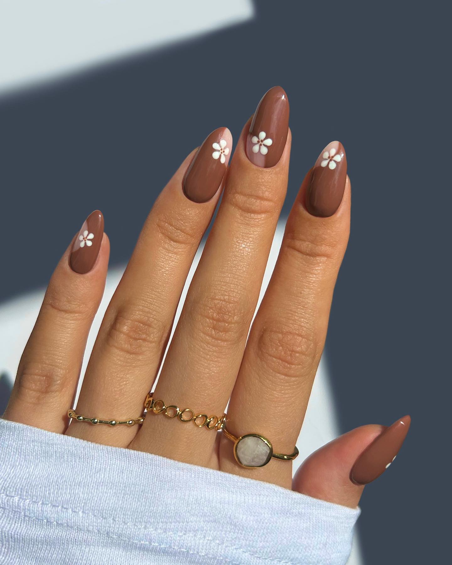 Brown Almond Nails with Delicate White Flowers
