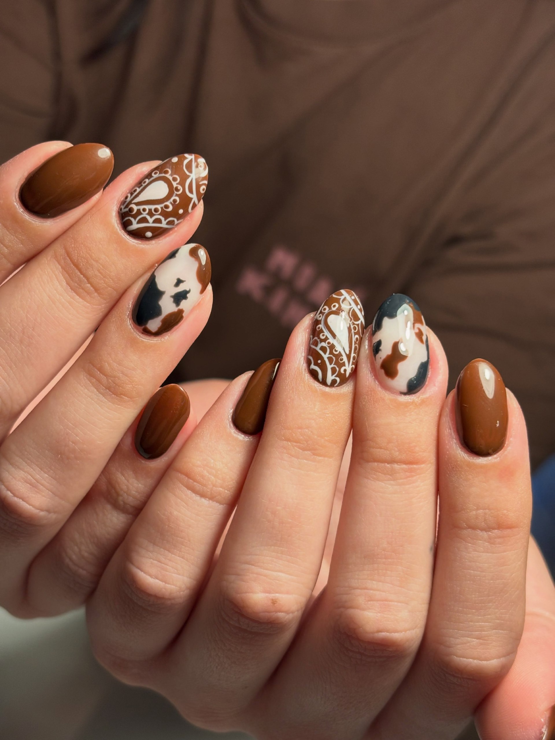 Brown Cow Print and Paisley Almond Nails