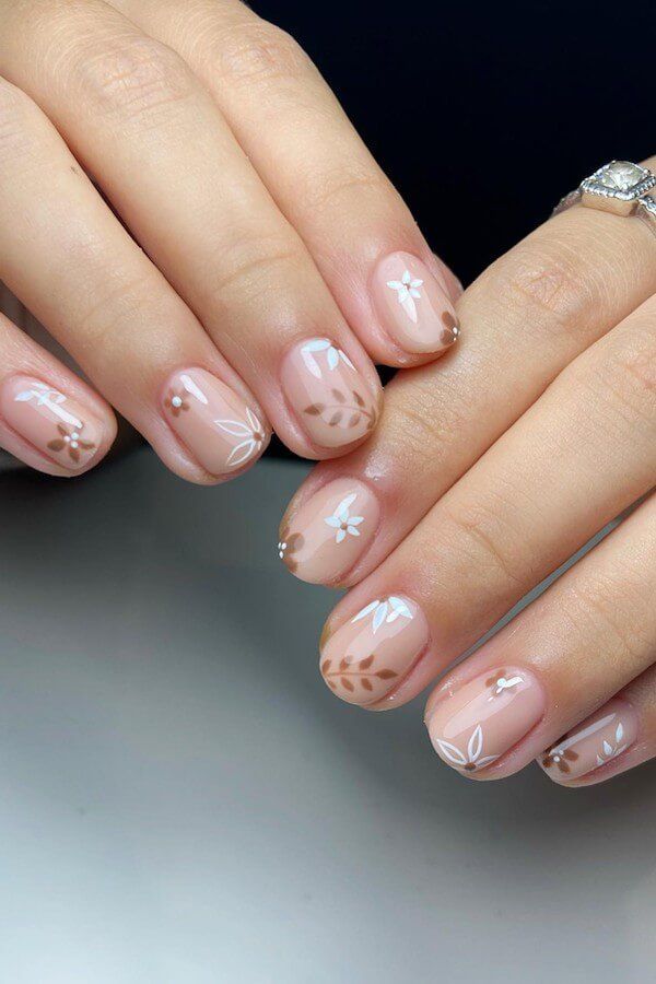 Elegant Nude Floral Accents Almond Nails