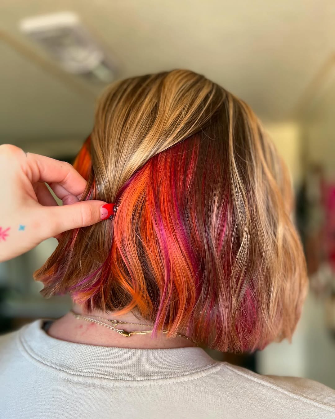 Fiery Peekaboo Highlights With Blonde Balayage Bob