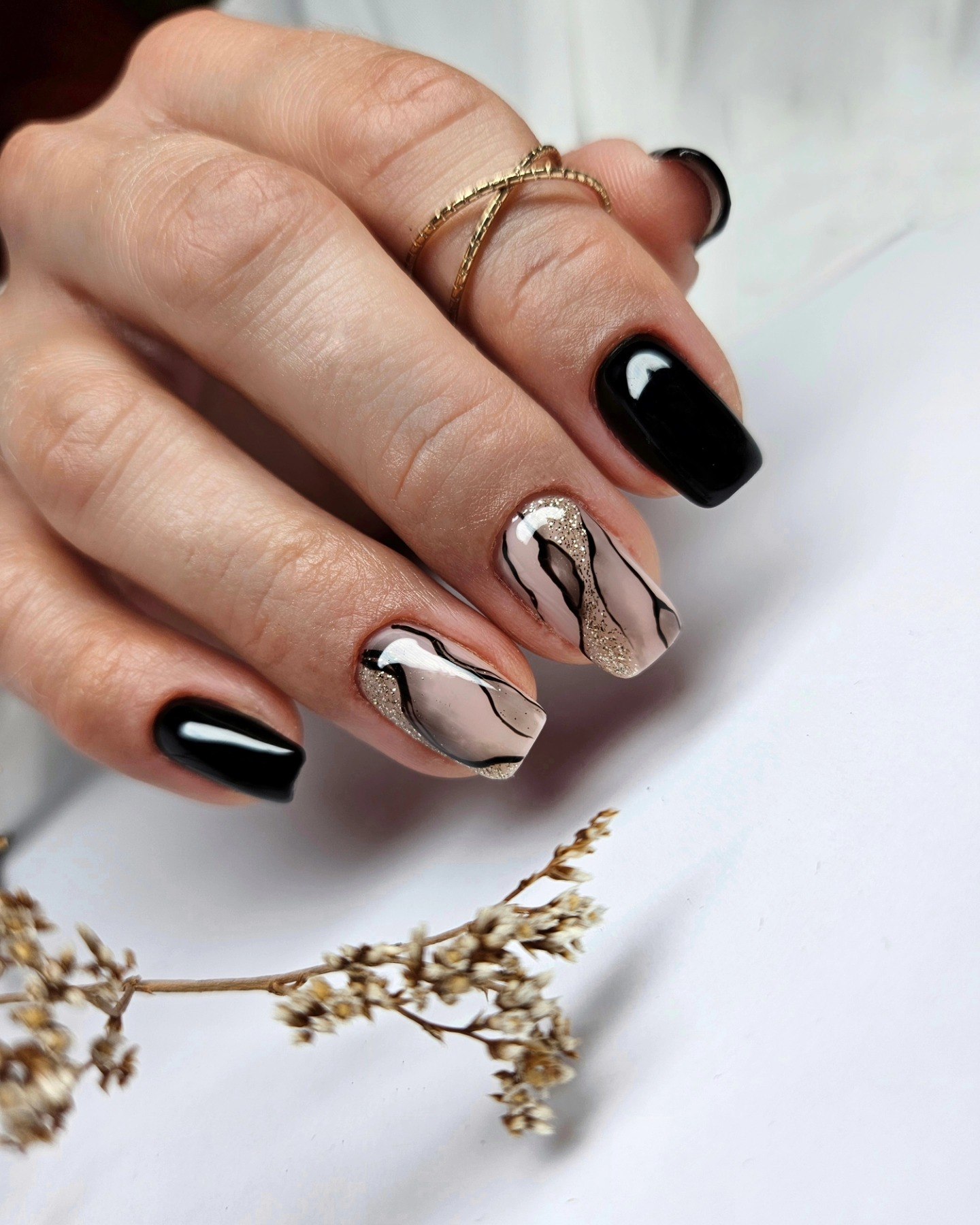 Glossy Black and Nude Swirl Nails