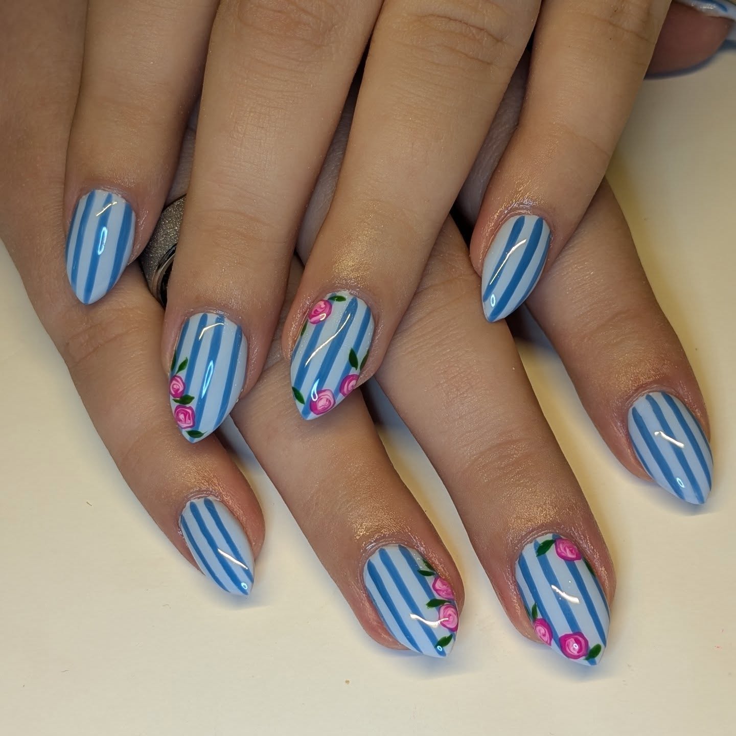 Glossy Blue Striped Nails With Pink Rose Accents