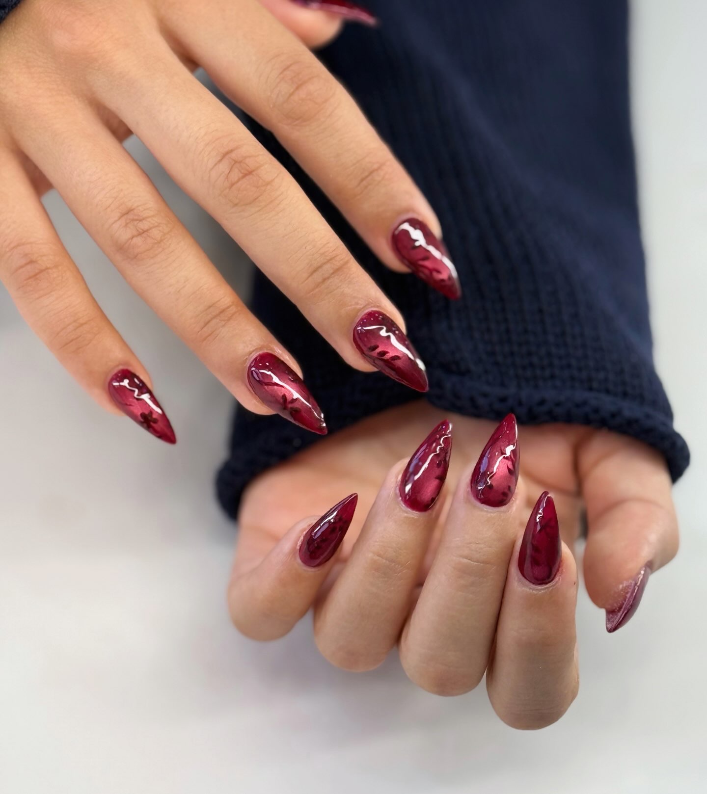 Glossy Burgundy Stiletto Swirl Nails