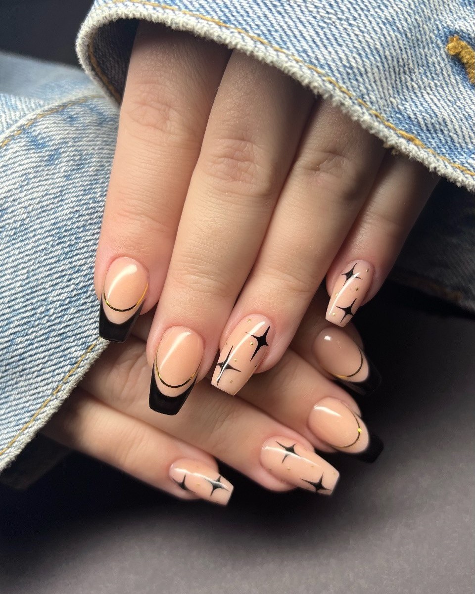 Glossy Nude Coffin Nails With Black Star Accents