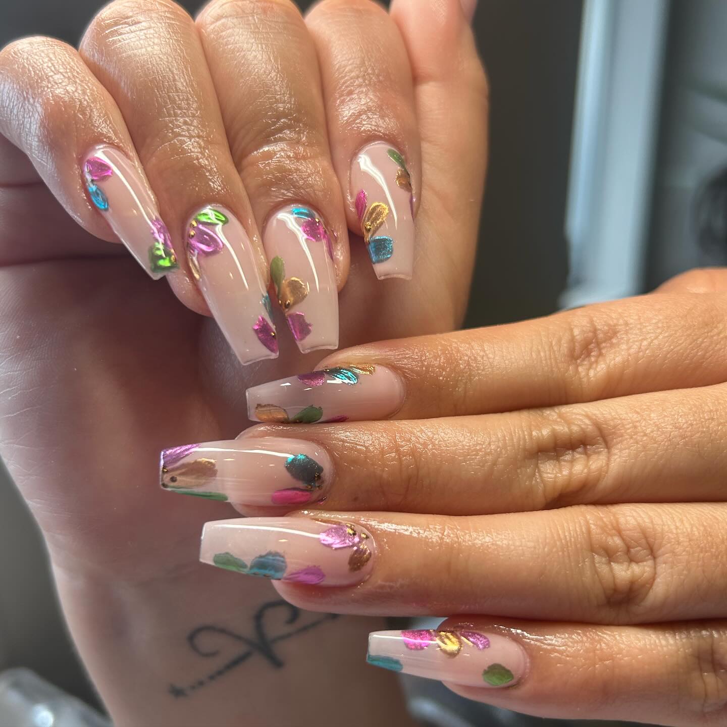 Glossy Nude Coffin Nails With Multicolored Metallic Accents
