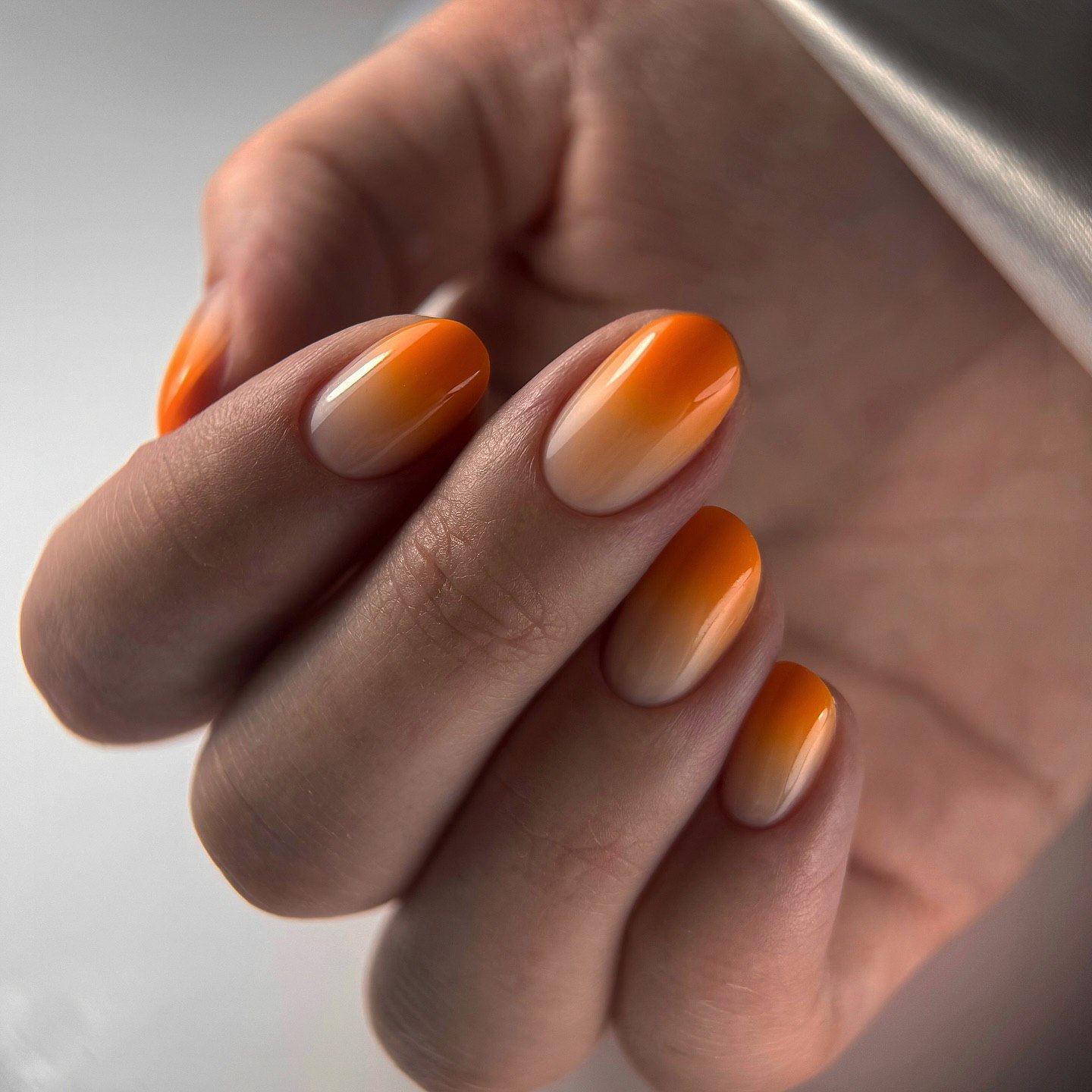 Glossy Orange Cream Ombre Oval Nails