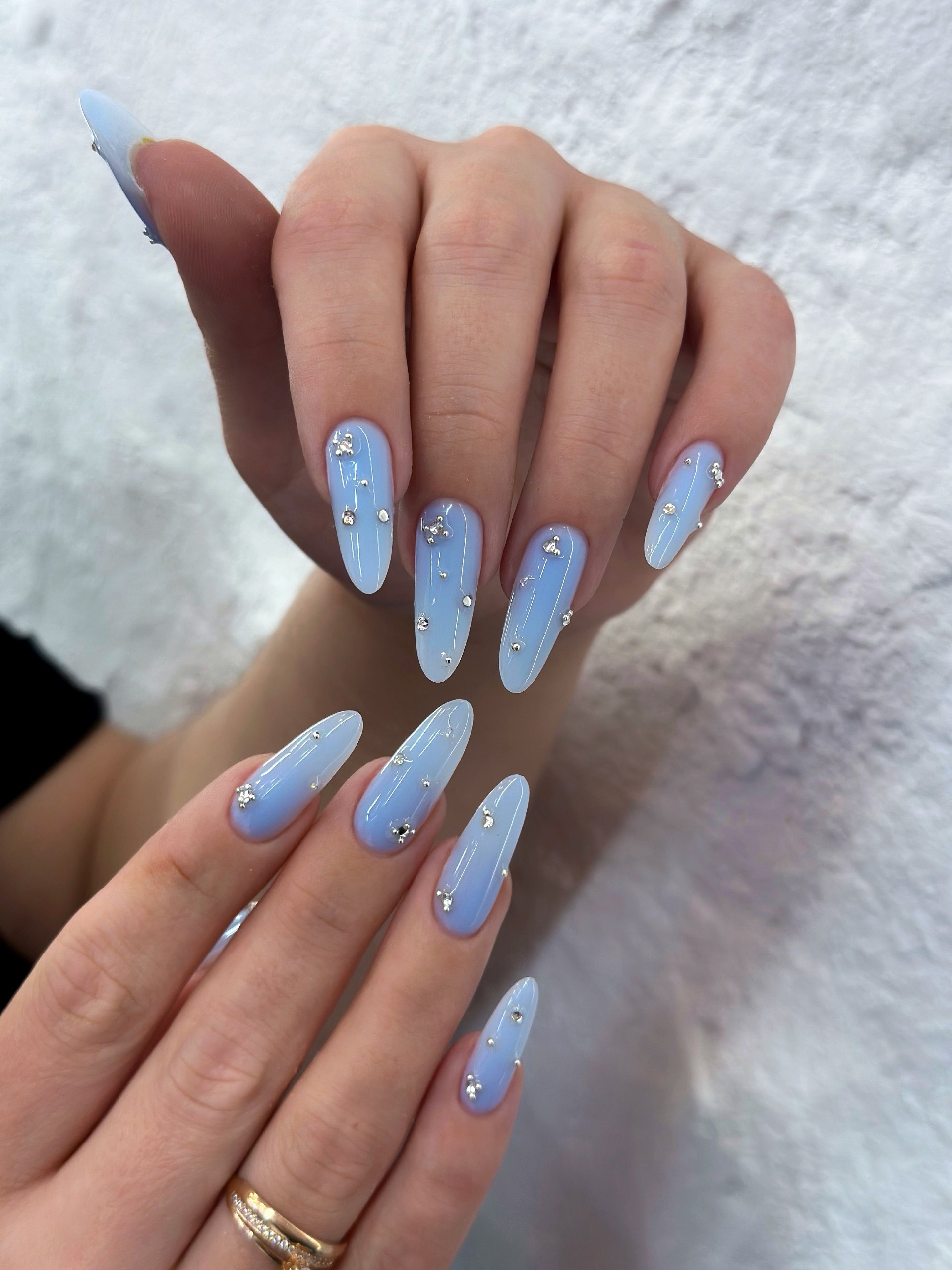 Icy Blue Almond Nails With Silver Stud Embellishments
