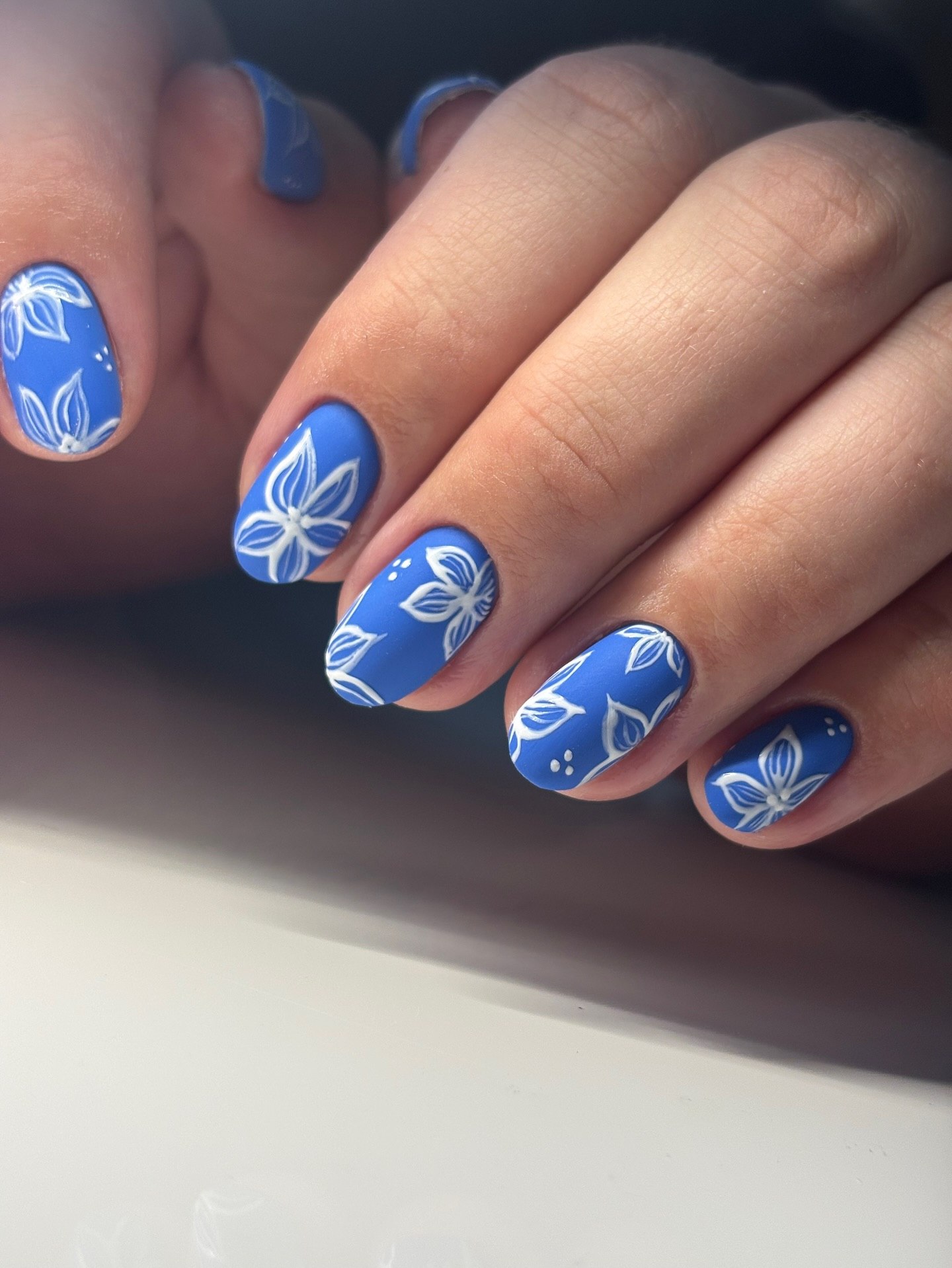 Matte Blue Nails With White Hand Painted Florals