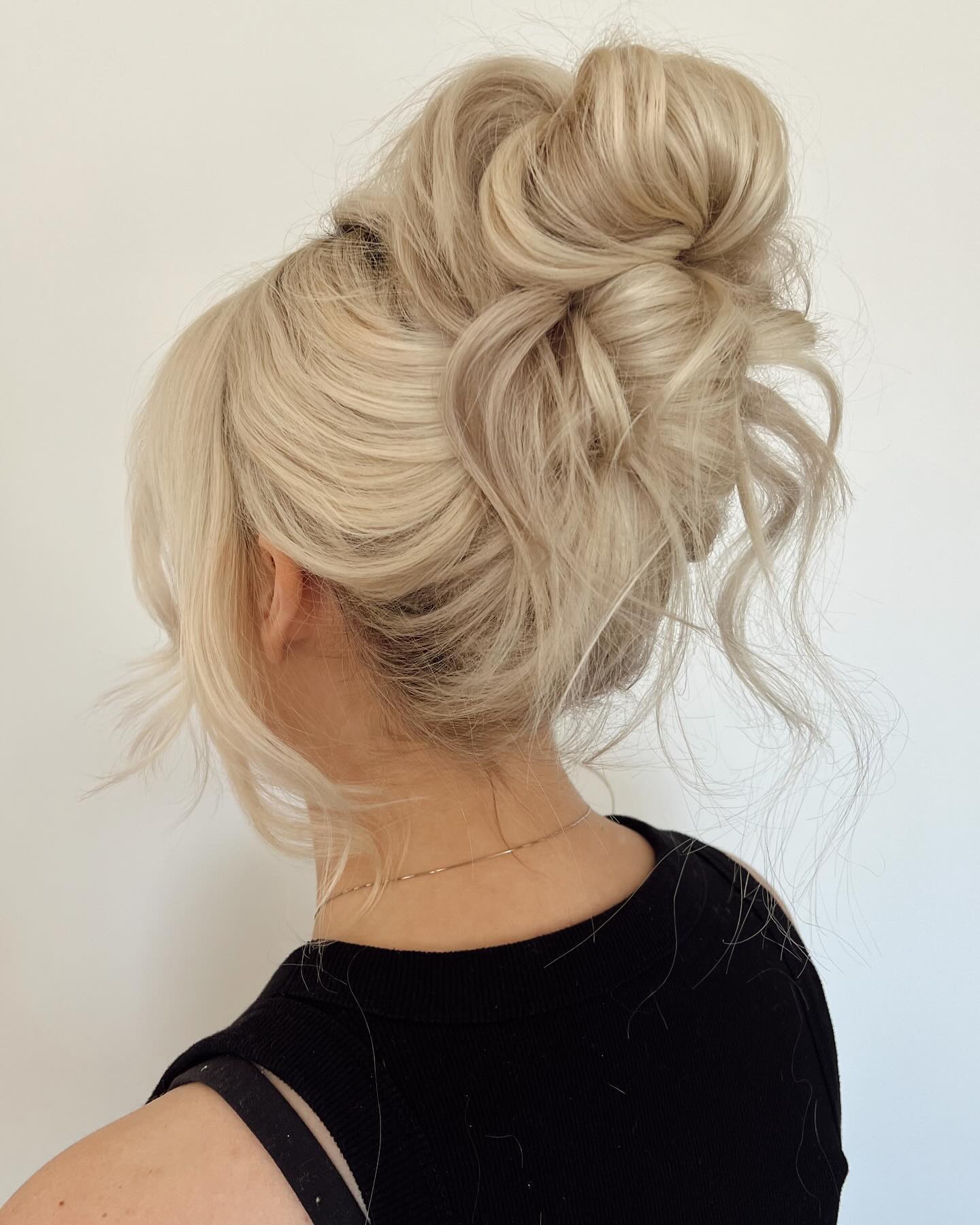 Messy Voluminous High Bun For Long Blonde Hair