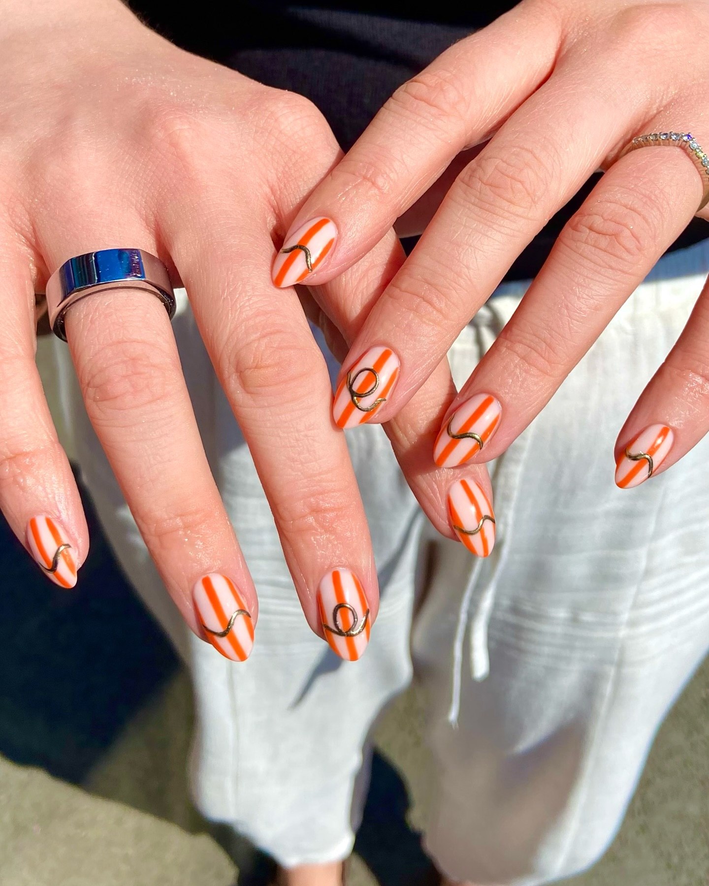 Orange & White Striped Oval Nails With Gold Swirls
