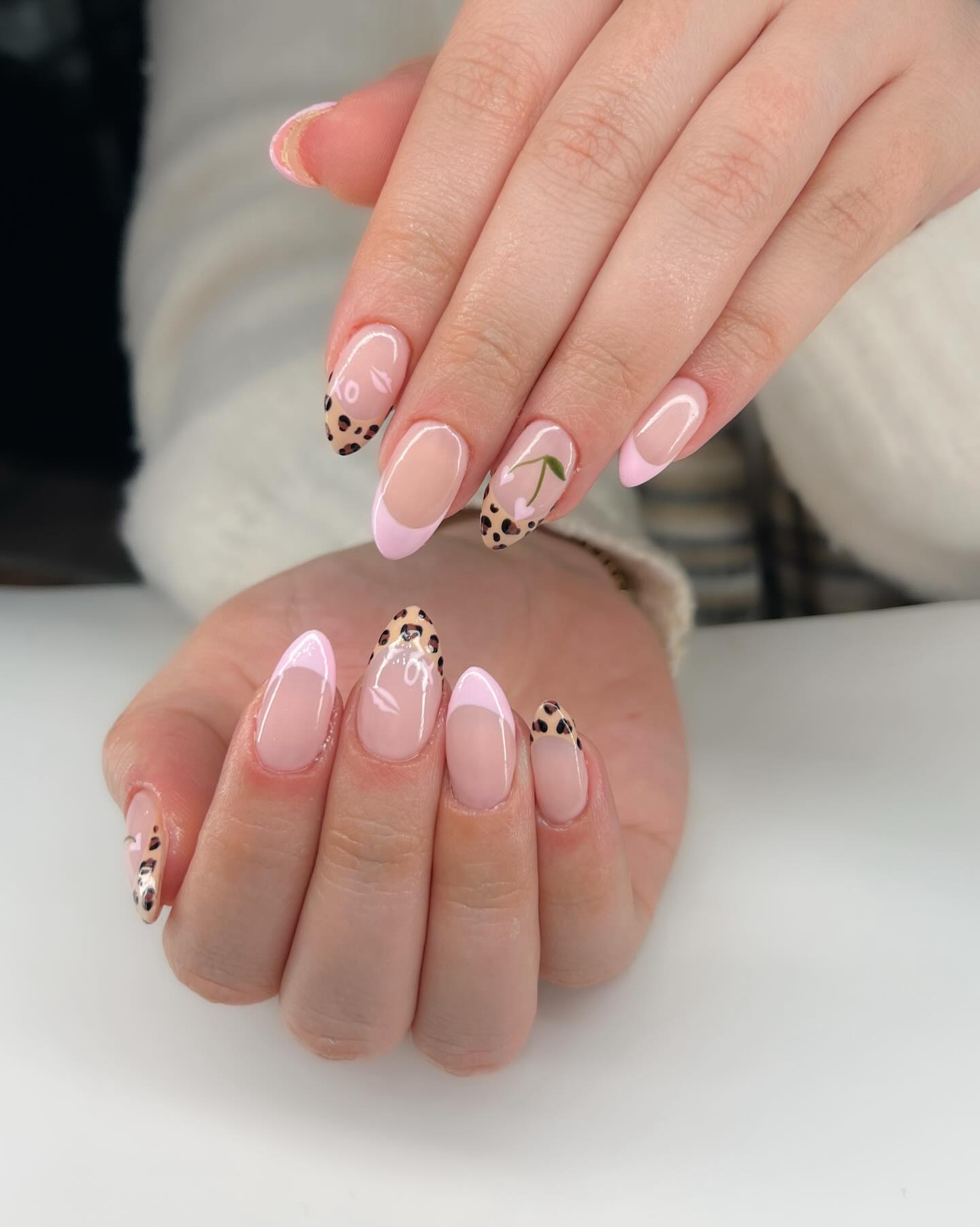 Pink French Tip Almond Nails with Leopard and Cherry Accents
