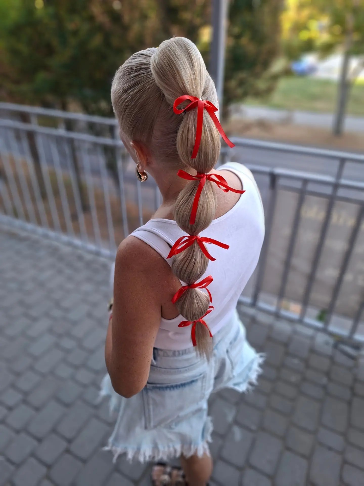 Playful Bubble Braid With Red Ribbon Accents