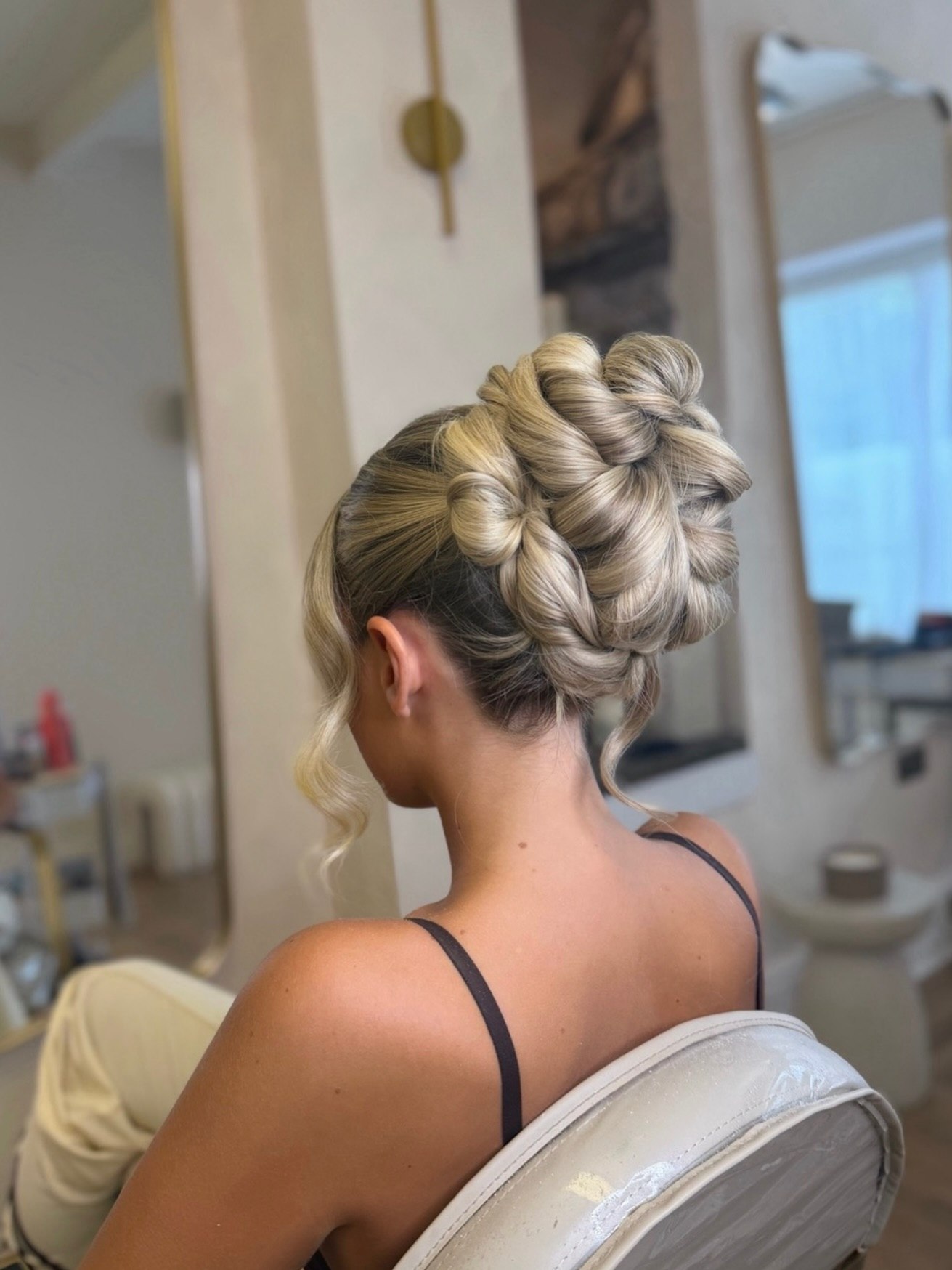 Sculpted Woven Chignon With Face Framing Tendrils