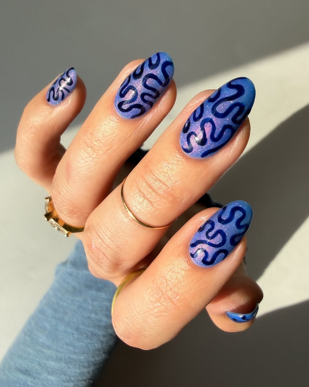 Shimmering Blue Swirl Almond Nails