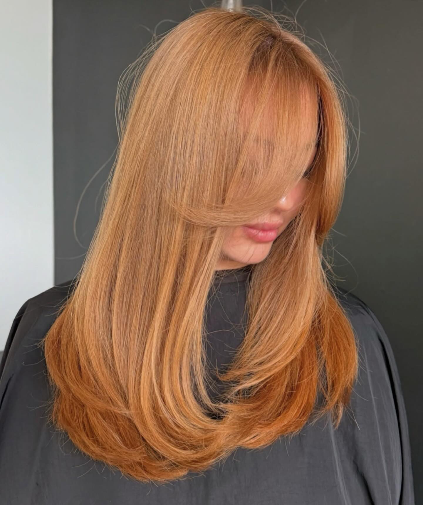 Soft Copper Layers With Face Framing Curtain Bangs