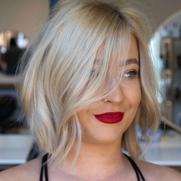 Textured Platinum Blonde Bob With Side Swept Bangs