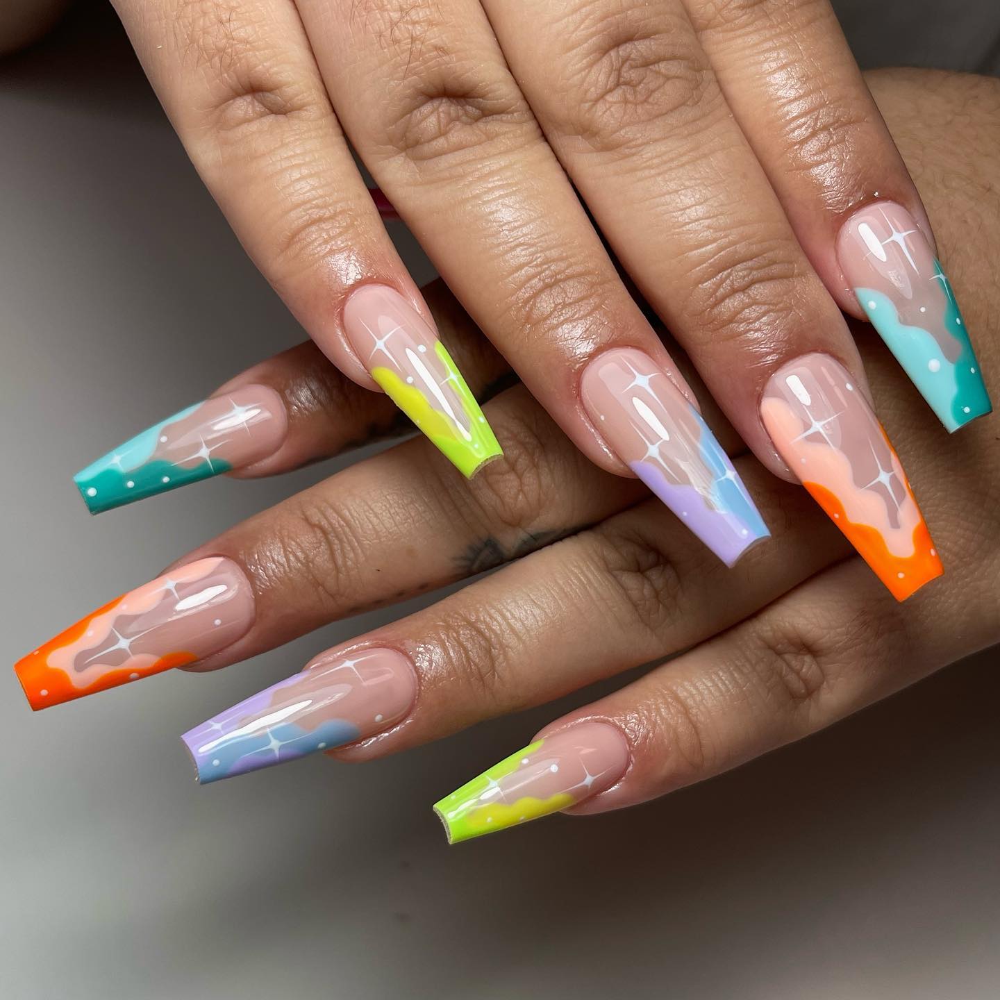 Vibrant Neon Swirl Coffin Nails With Star Accents