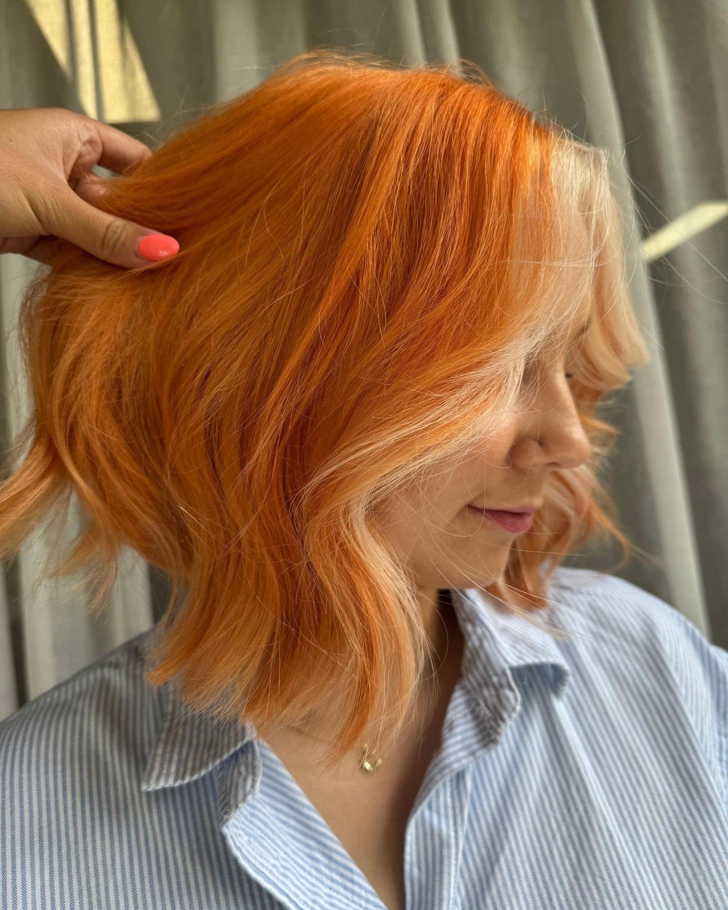 Vibrant Tangerine Bob With Platinum Face Framing