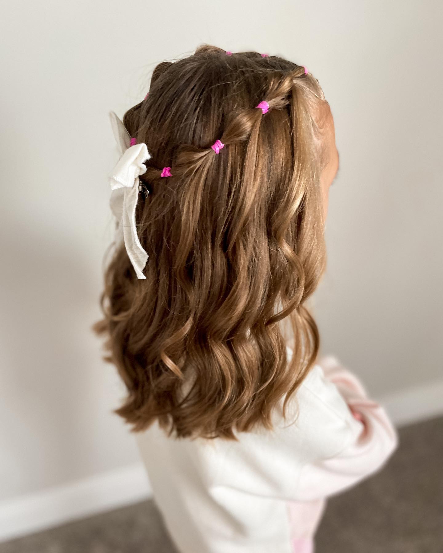Adorable Braided Pigtails With Pink Elastics and White Bow