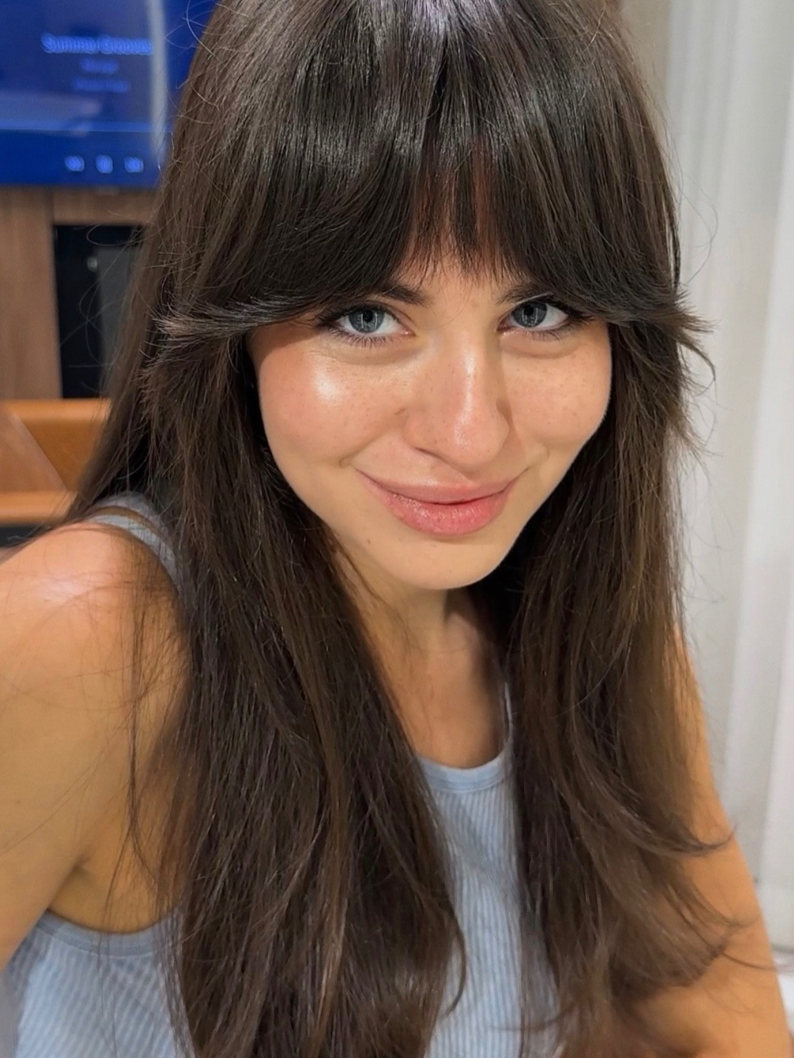 Effortless Face-Framing Bangs On Long Brunette Waves