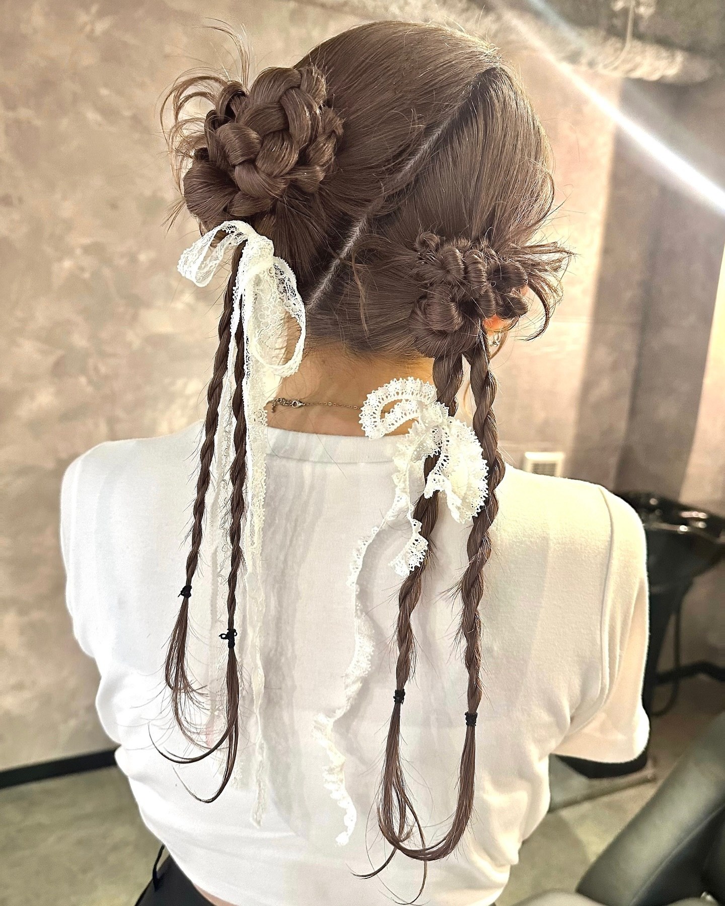 Lace-Adorned Double Braided Buns With Cascading Pigtails