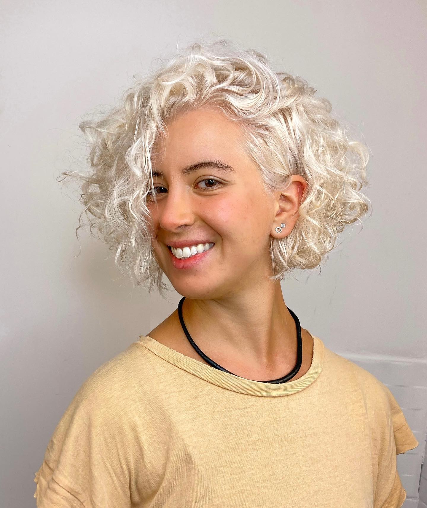 Platinum Blonde Beachy Curls With Face Framing